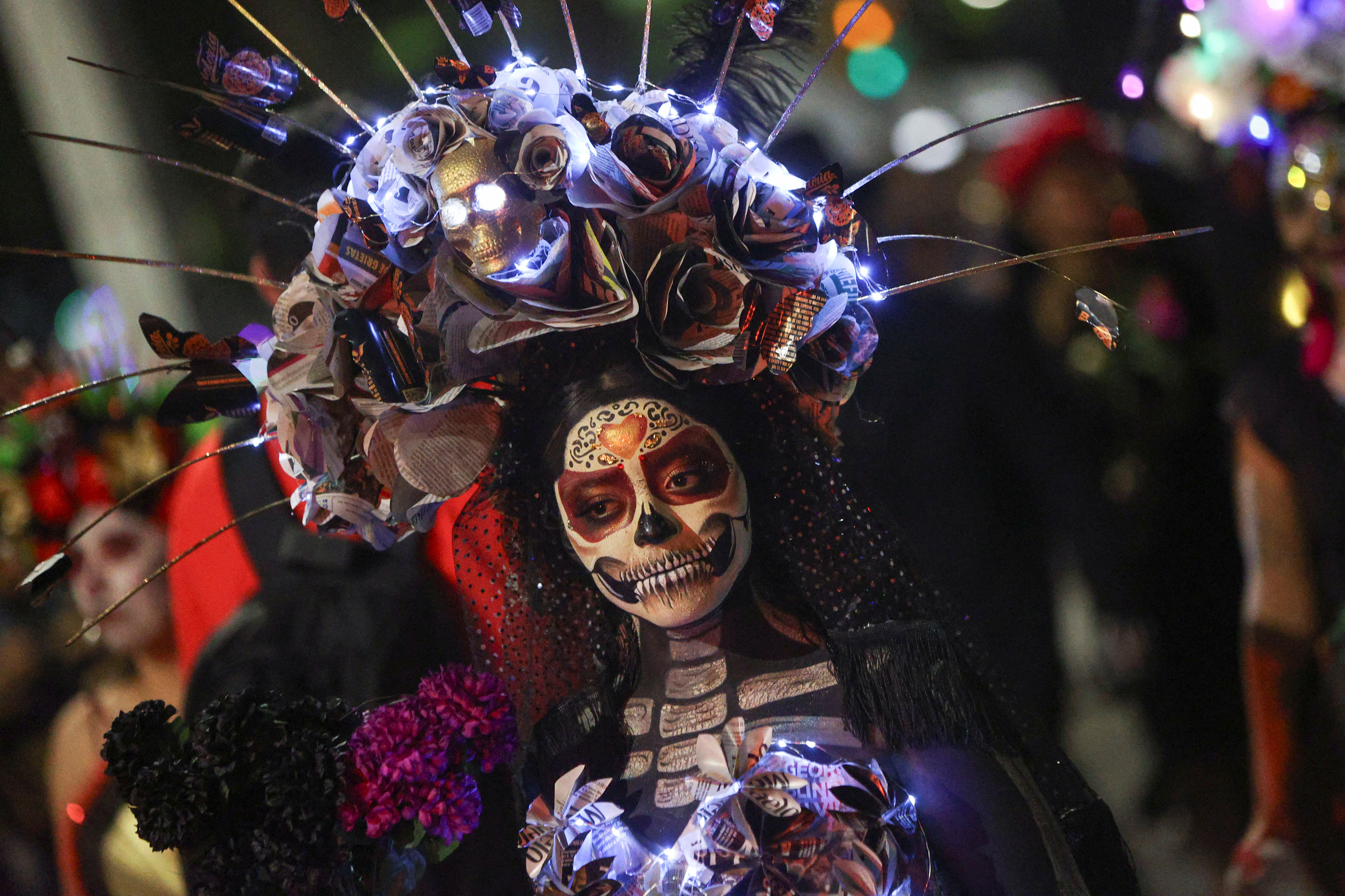 Participants take part in a parade ahead of the Day of the Dead celebrations, in Mexico City