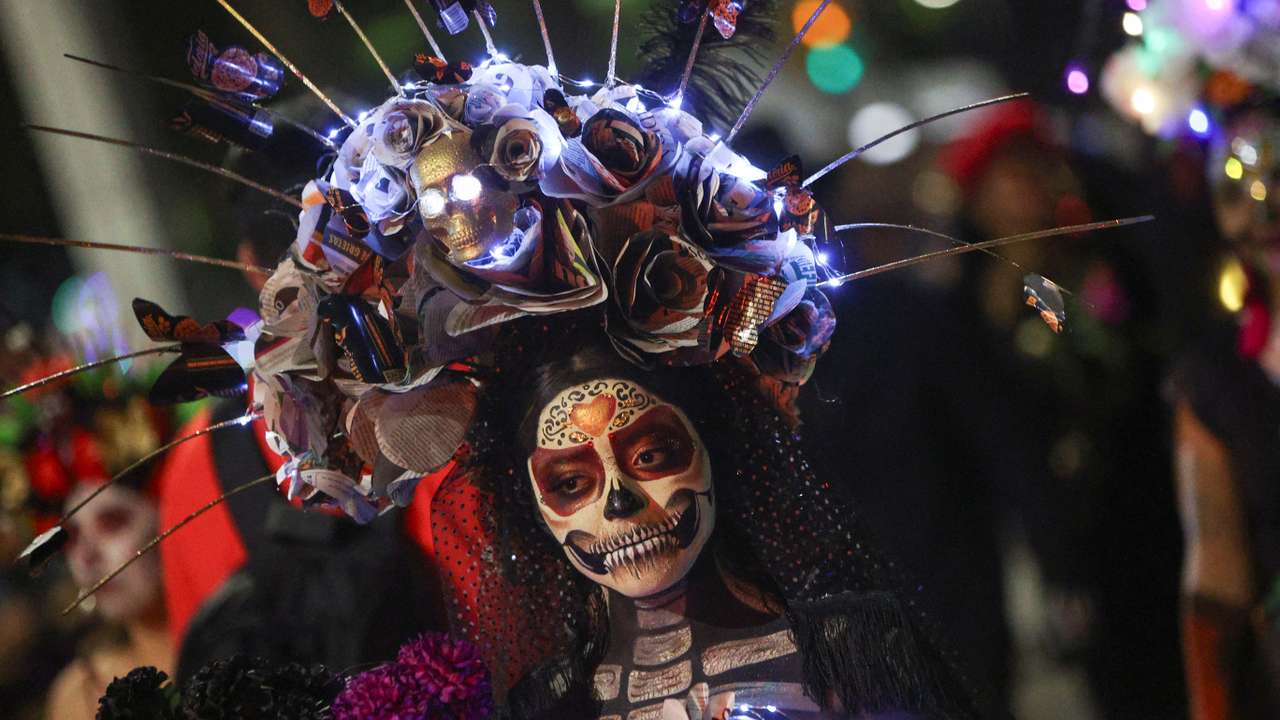 Participants take part in a parade ahead of the Day of the Dead celebrations, in Mexico City