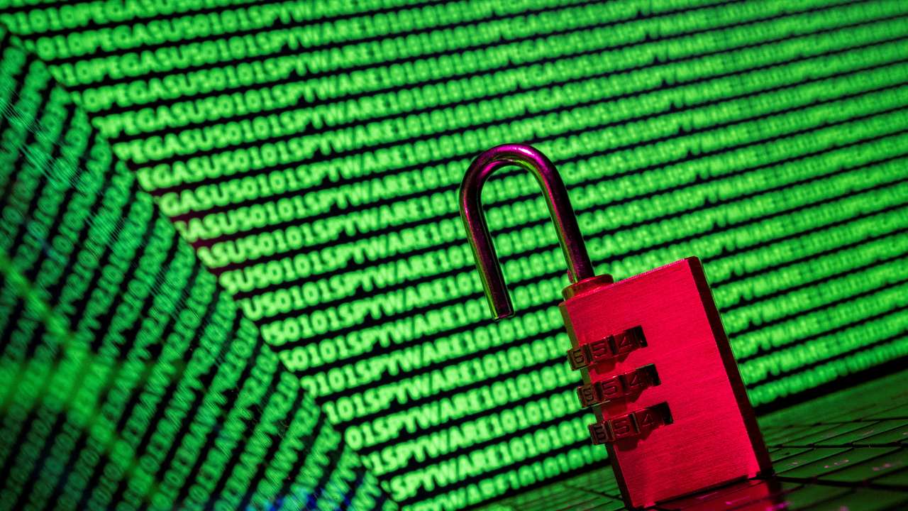 FILE PHOTO: Illustration shows a padlock in front of the word Spyware and binary code