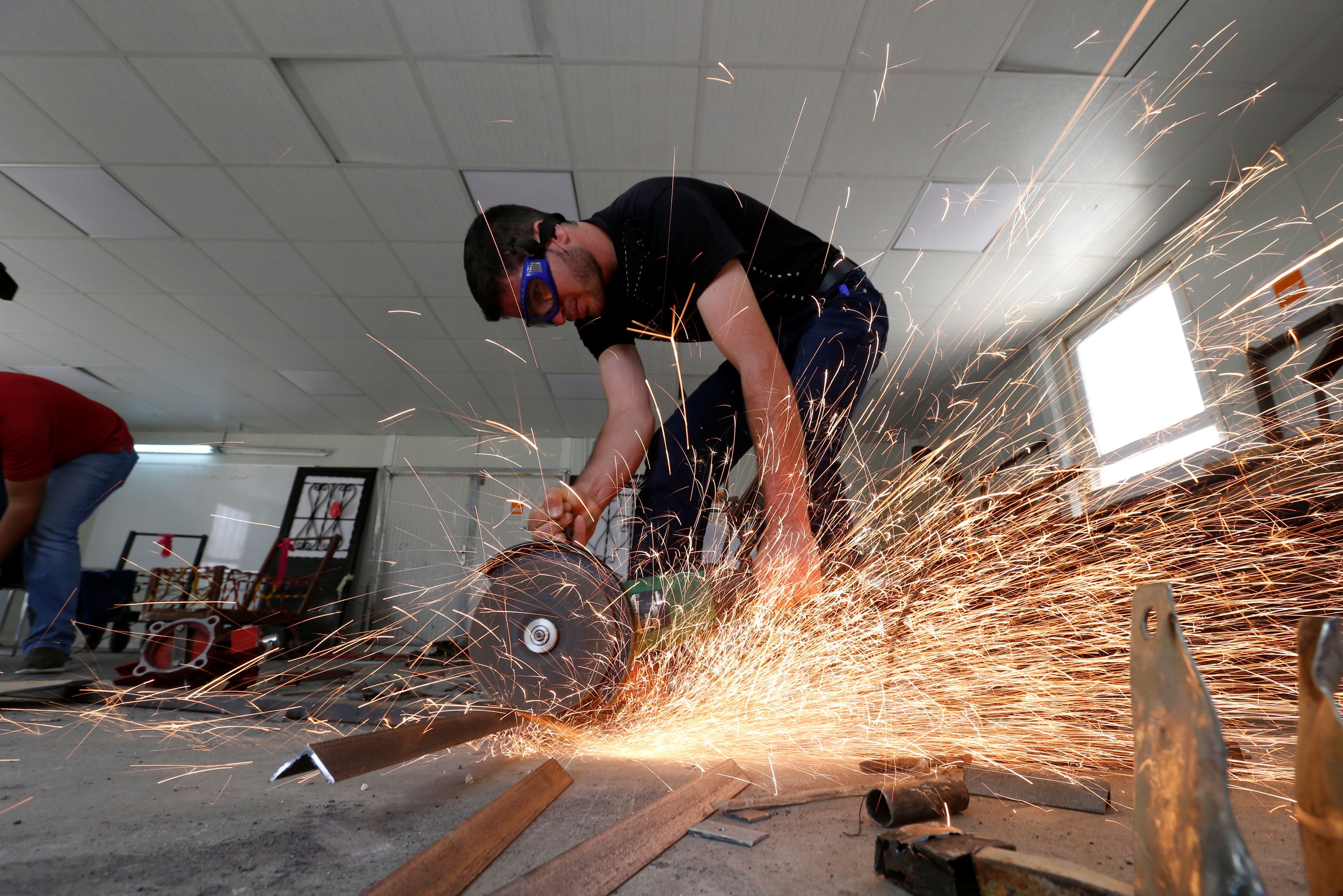 Syrian refugee metal shop trainees work at one of the vocational training centres of The Norwegian Refugee Council (NRC) at Azraq refugee camp