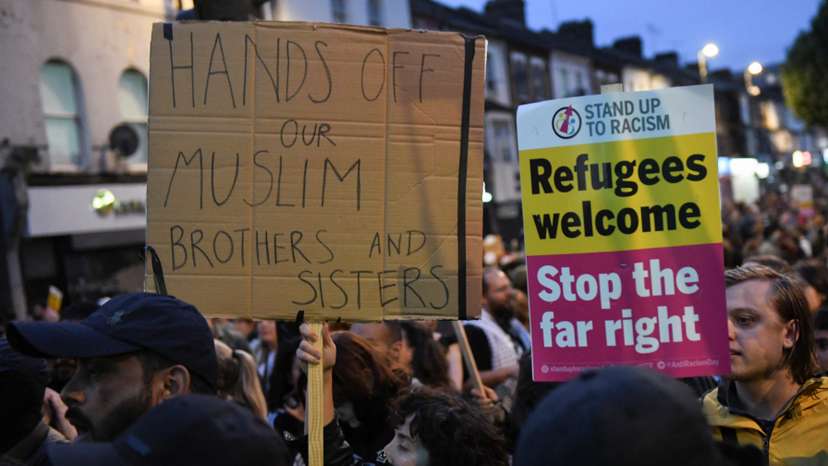People gather against an an anti-immigration protest, in London