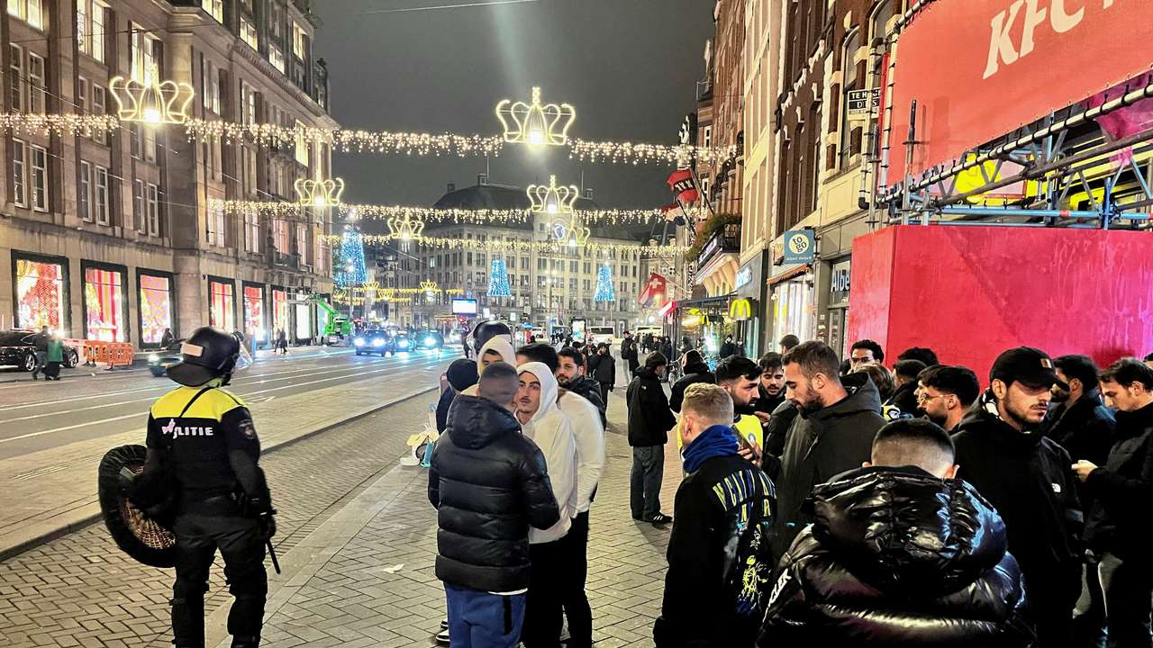 Israeli football supporters are guarded by police after violence targeting Israeli football fans broke out in Amsterdam overnight, in Amsterdam