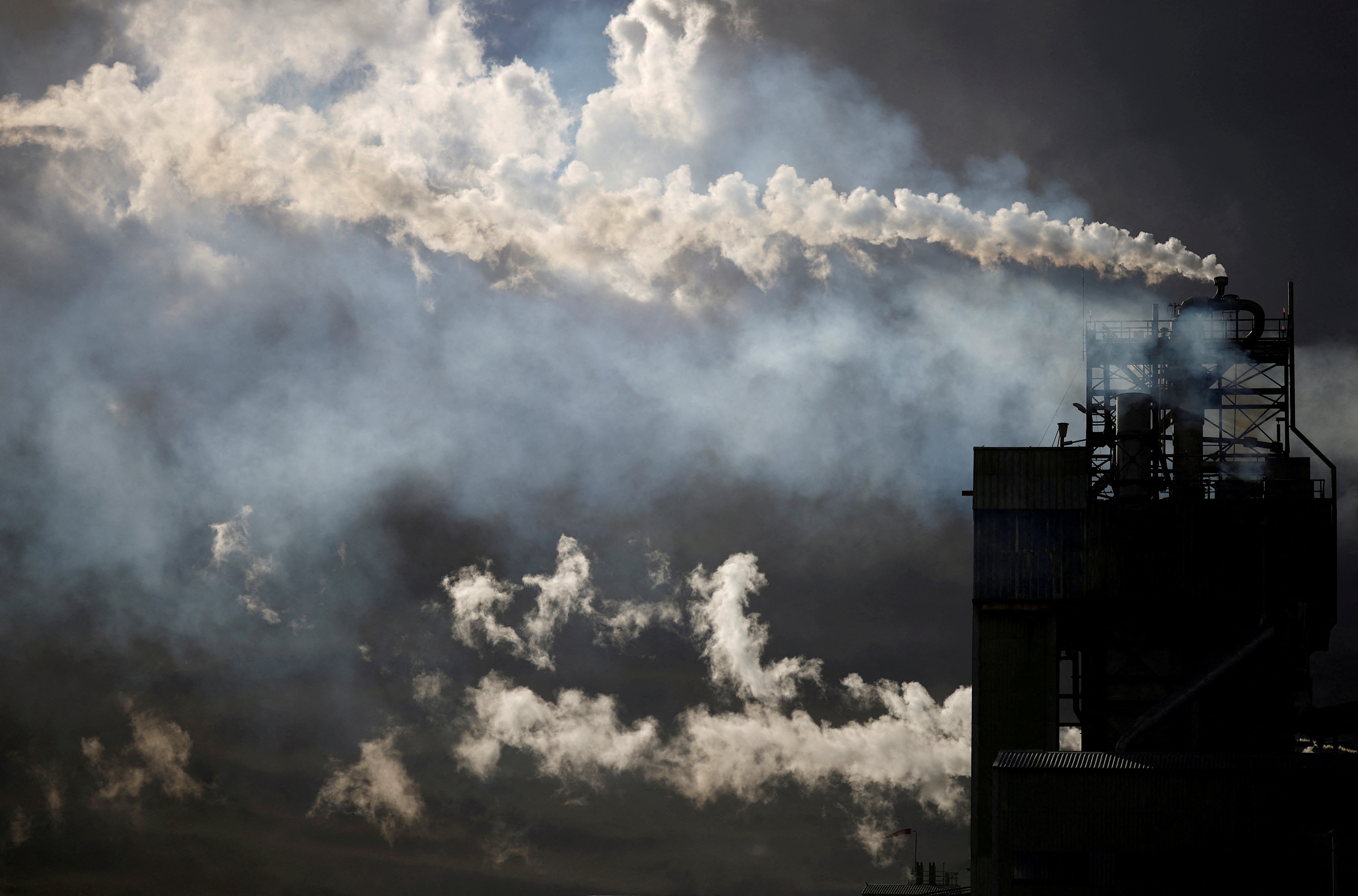 FILE PHOTO: Emissions from the chimneys of Yara France plant in Montoir-de-Bretagne near Saint-Nazaire