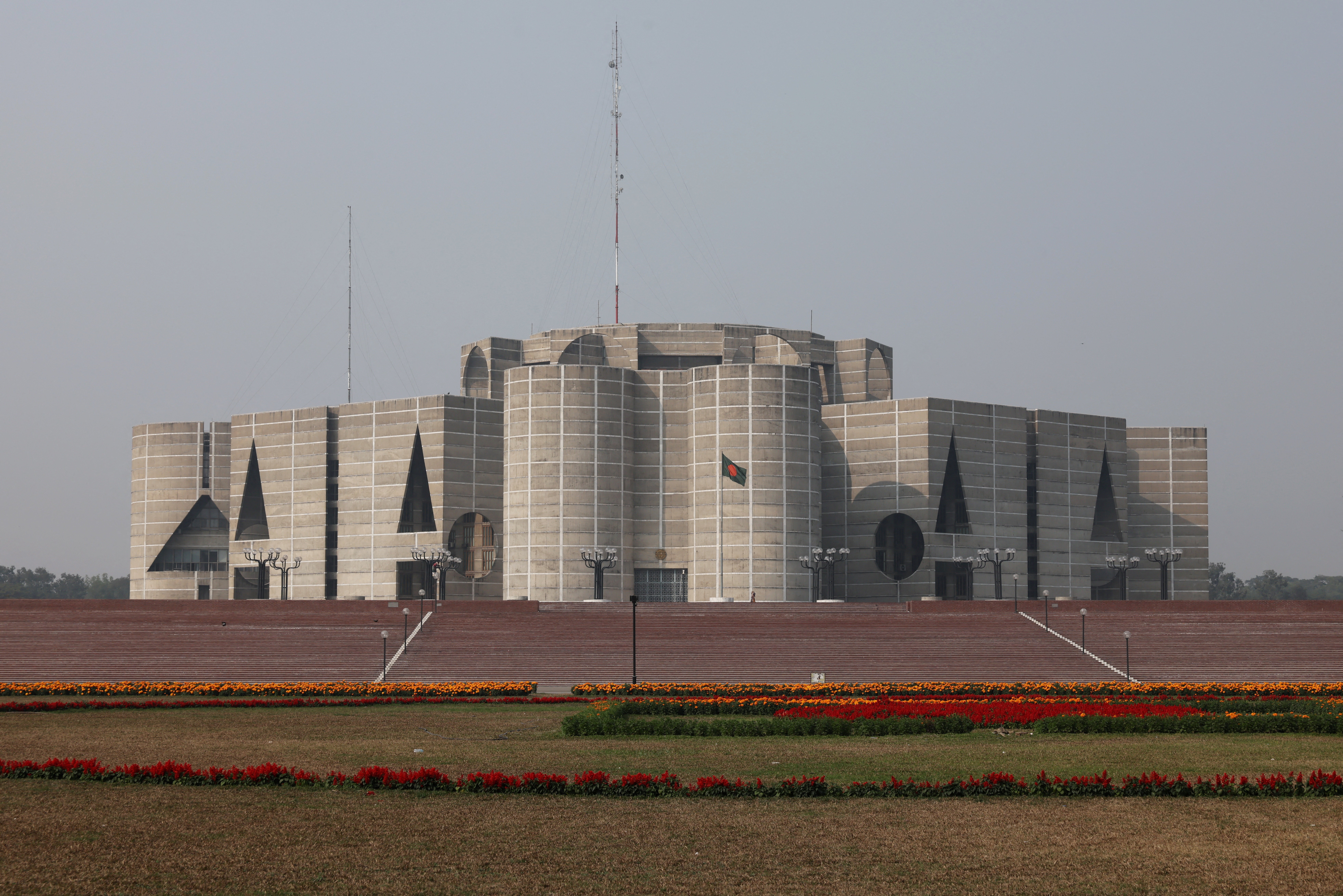 Bangladeshi national flag waves in front of the parliament building ahead of the national election, in Dhaka