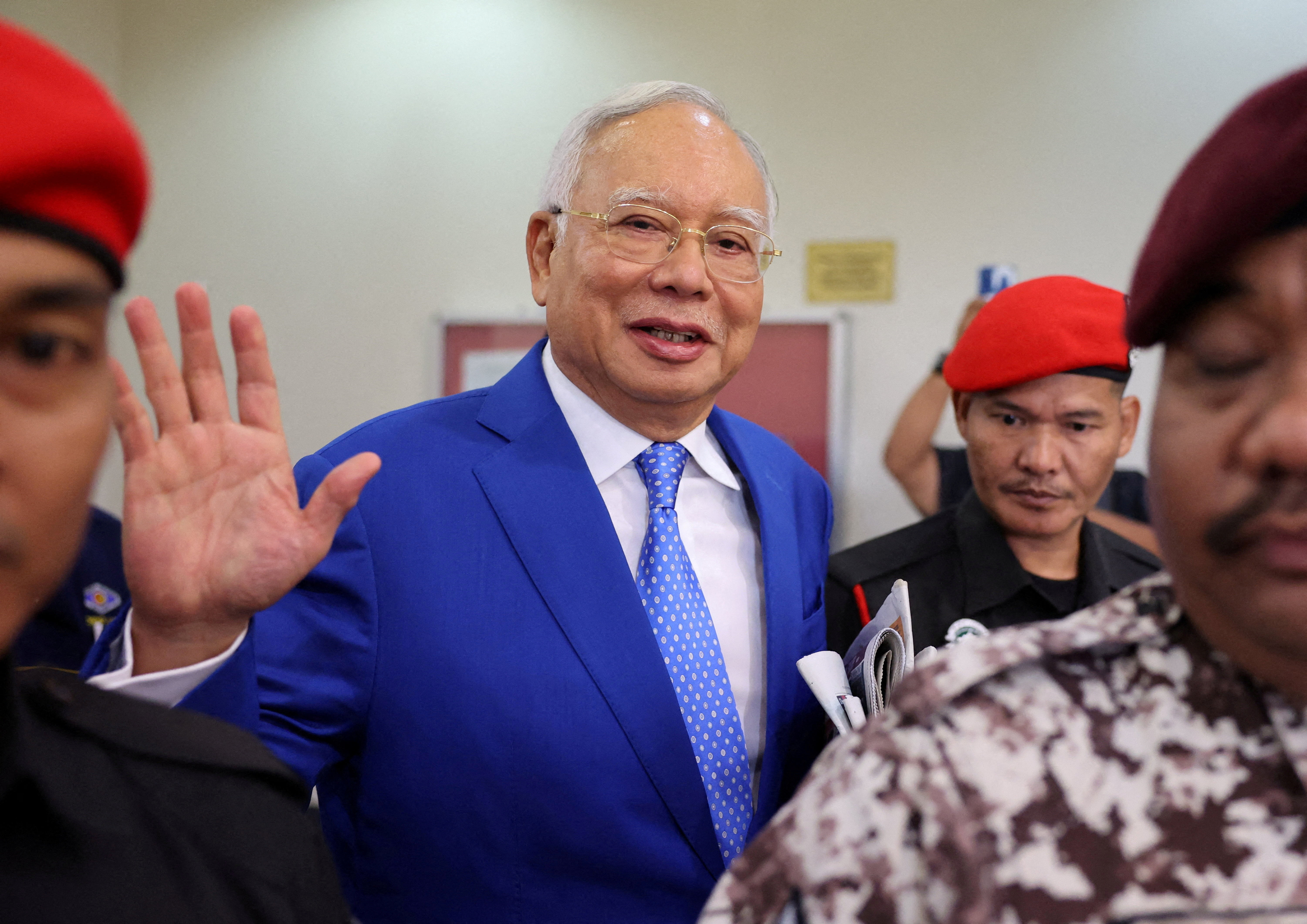 FILE PHOTO: Former Malaysian Prime Minister Najib Razak waves to photographers at Kuala Lumpur