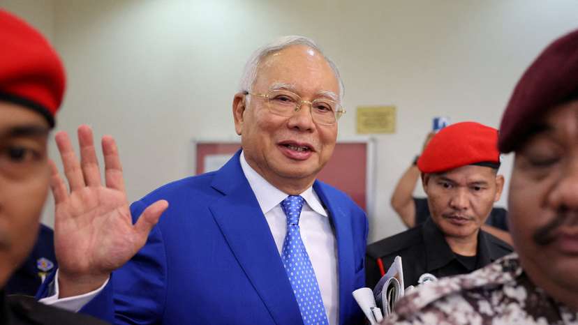 FILE PHOTO: Former Malaysian Prime Minister Najib Razak waves to photographers at Kuala Lumpur