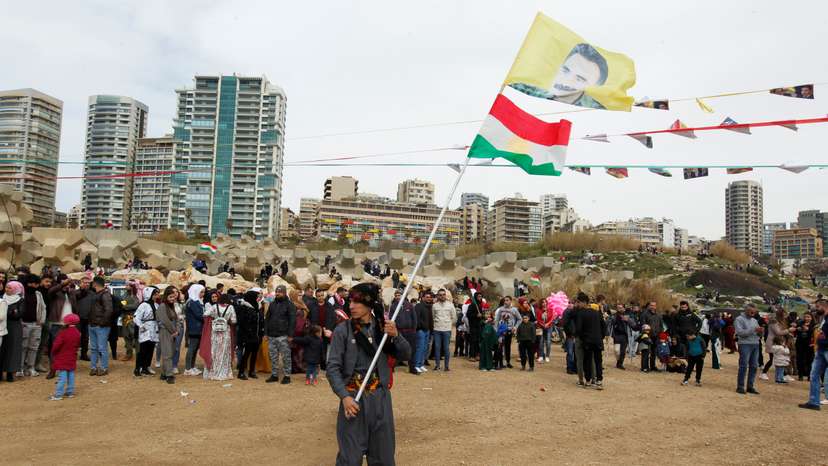 A Kurdish man carries a flag with a portrait of jailed Kurdistan Workers Party (PKK) leader Abdullah Ocalan during Nowruz festival celebrations, in Beirut
