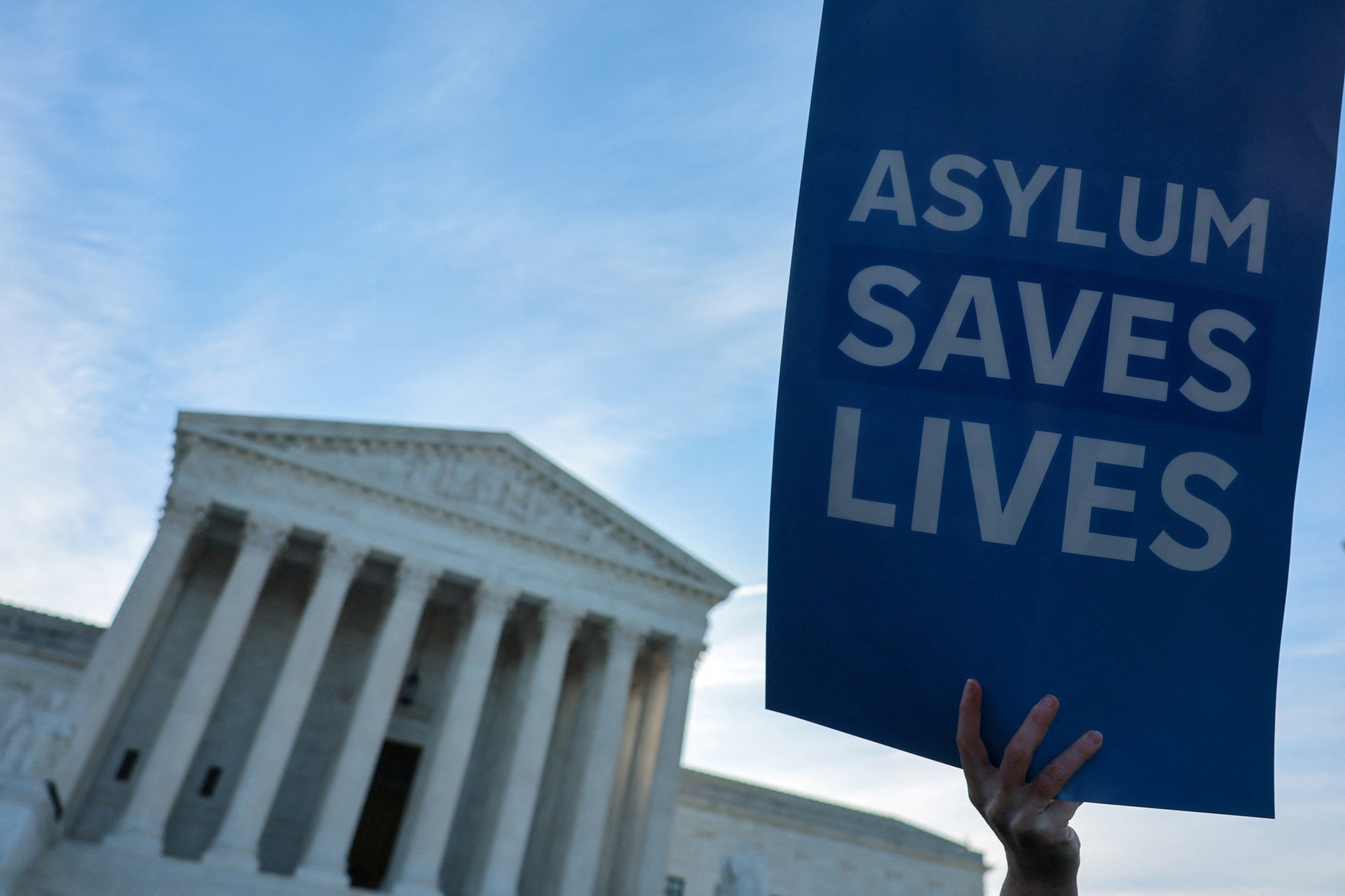 Demonstrators gather for a vigil prior to arguments in Noem v. Al Otro Lado at the U.S. Supreme Court building in Washington