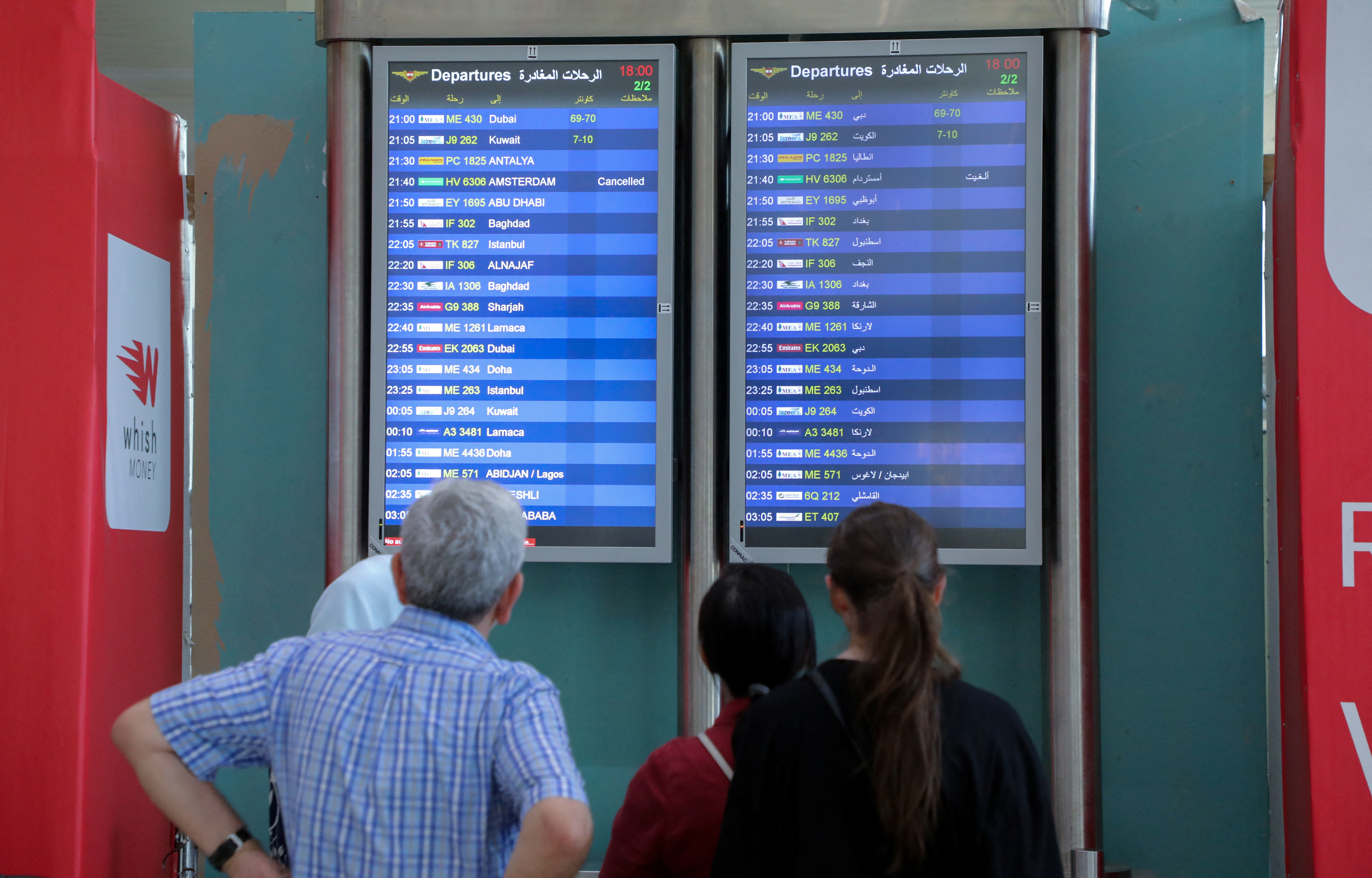 People look at flight information boards at Beirut–Rafic Hariri International Airport