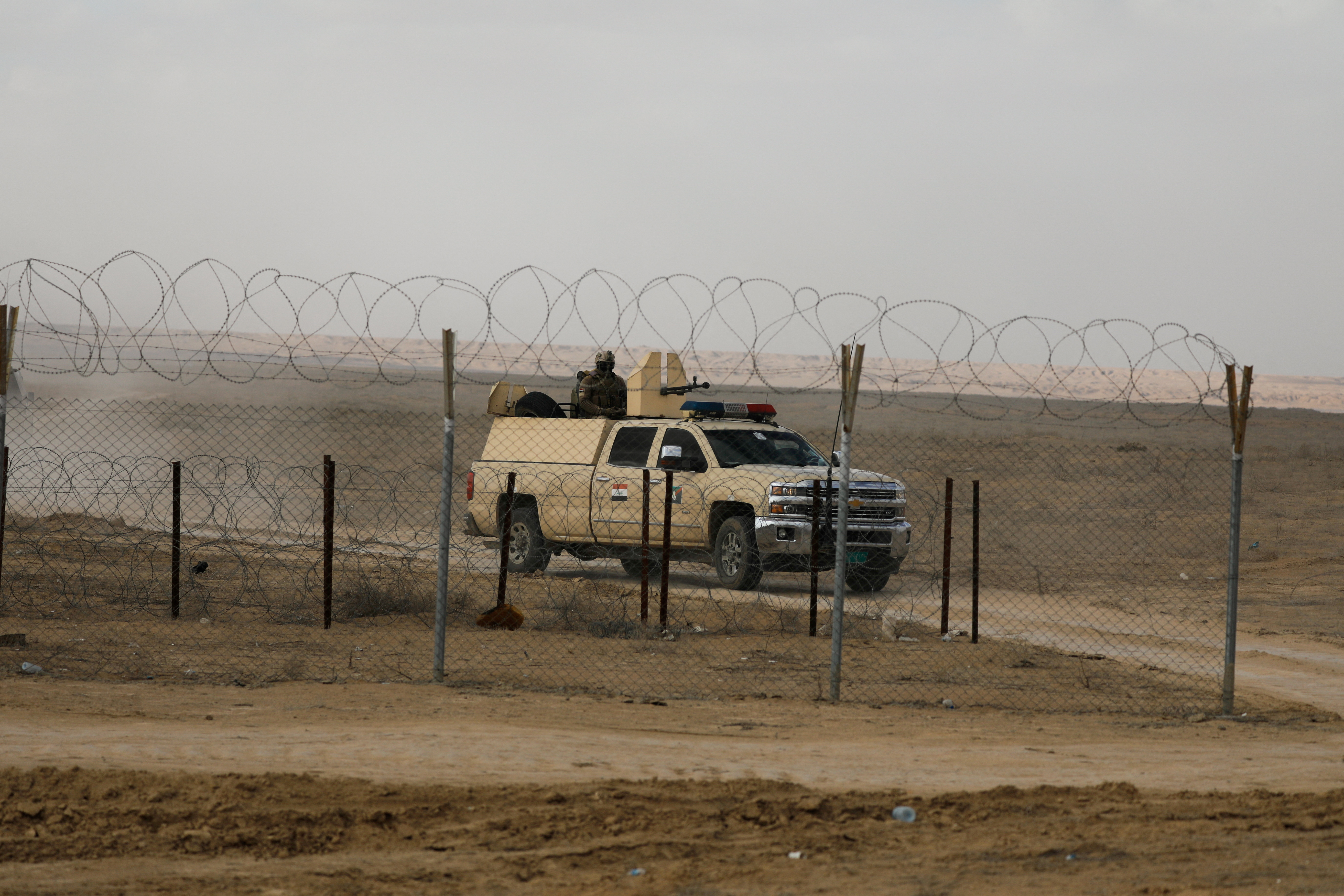 FILE PHOTO: Iraqi military vehicle patrols near Iraqi-Syrian border
