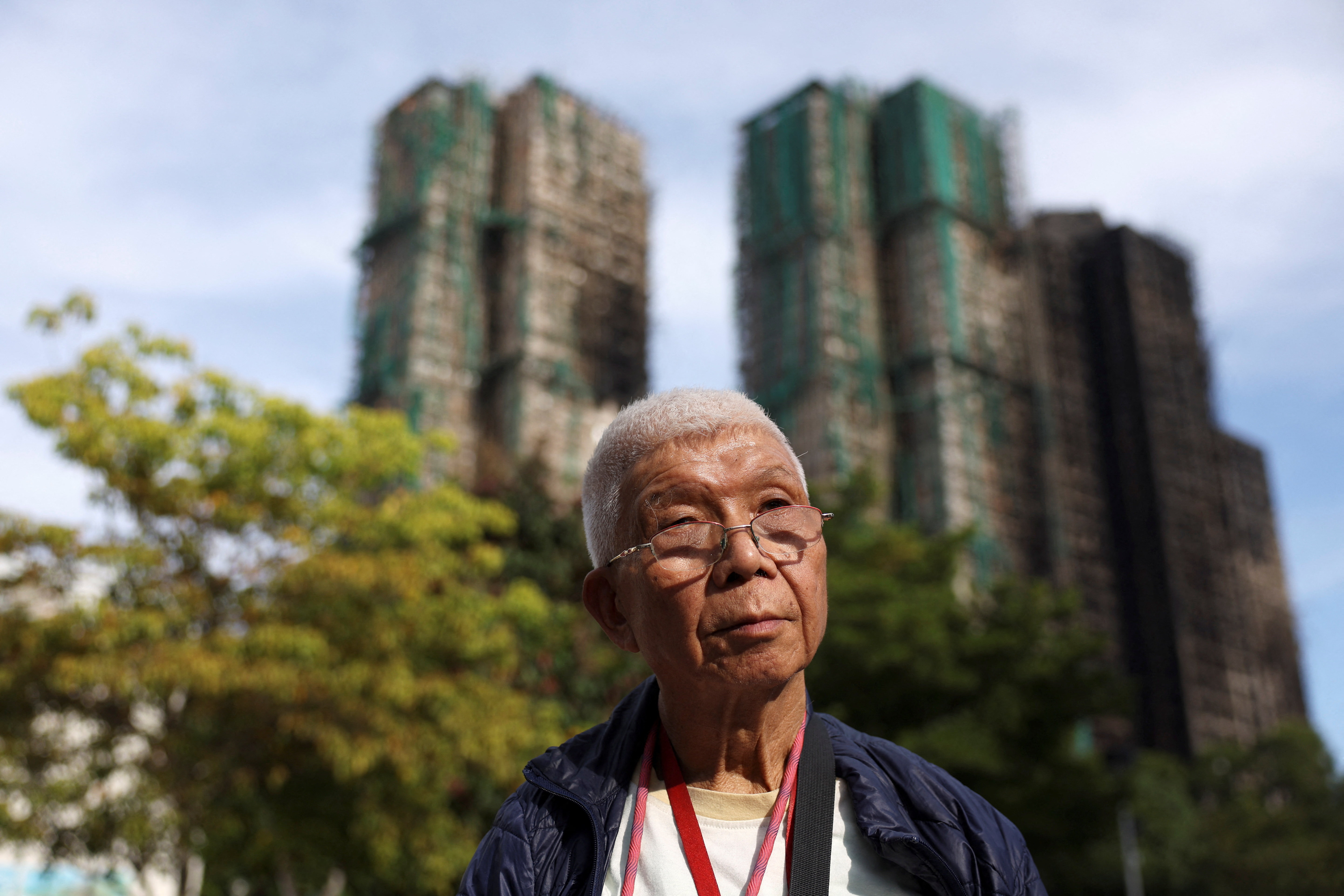 David Ho, whose ex-wife and son are among the missing people in the deadly fire at the Wang Fuk Court housing complex, poses for pictures in Hong Kong