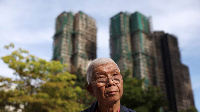 David Ho, whose ex-wife and son are among the missing people in the deadly fire at the Wang Fuk Court housing complex, poses for pictures in Hong Kong