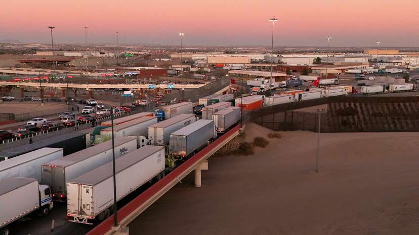Trucks queue to cross into the United States as new tariffs are expected soon