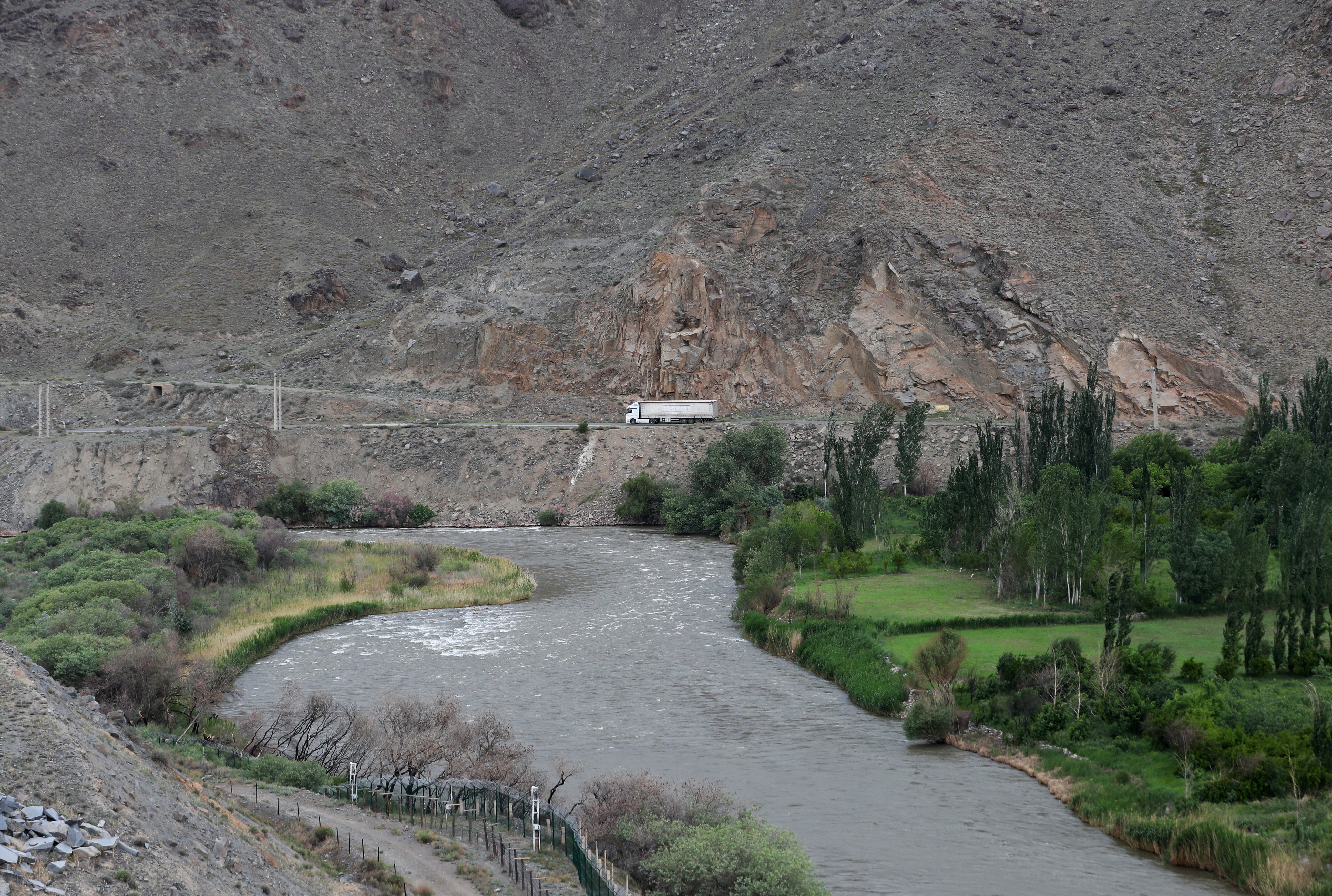 FILE PHOTO: A truck drives on a road in the border region of Iran, as seen from the Syunik Province of Armenia