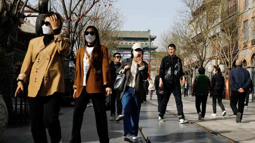 FILE PHOTO: People walk at the tourism site of Qianmen street, in Beijing,