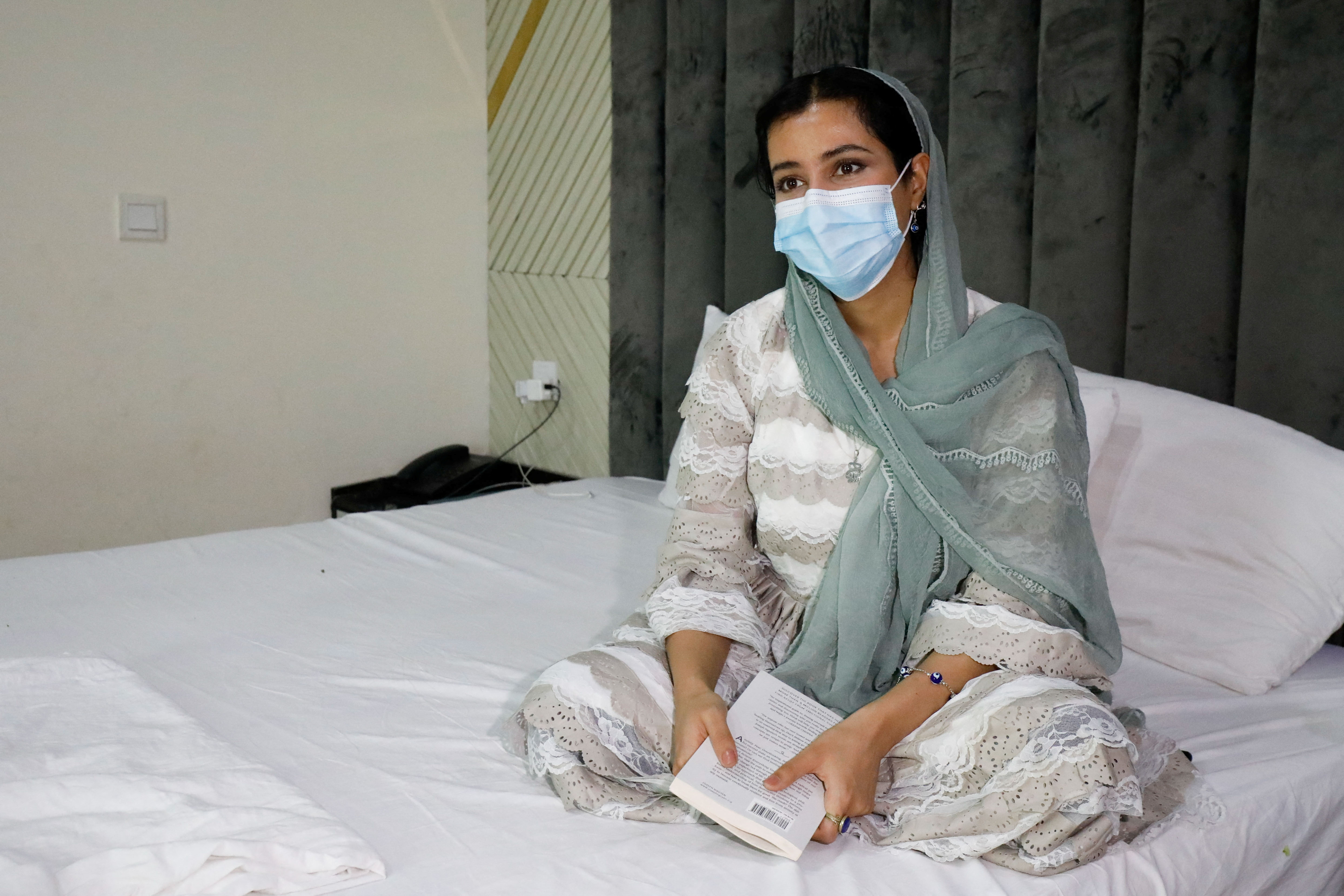 Kimia, 25, an Afghan journalist and artist, speaks with Reuters in Islamabad
