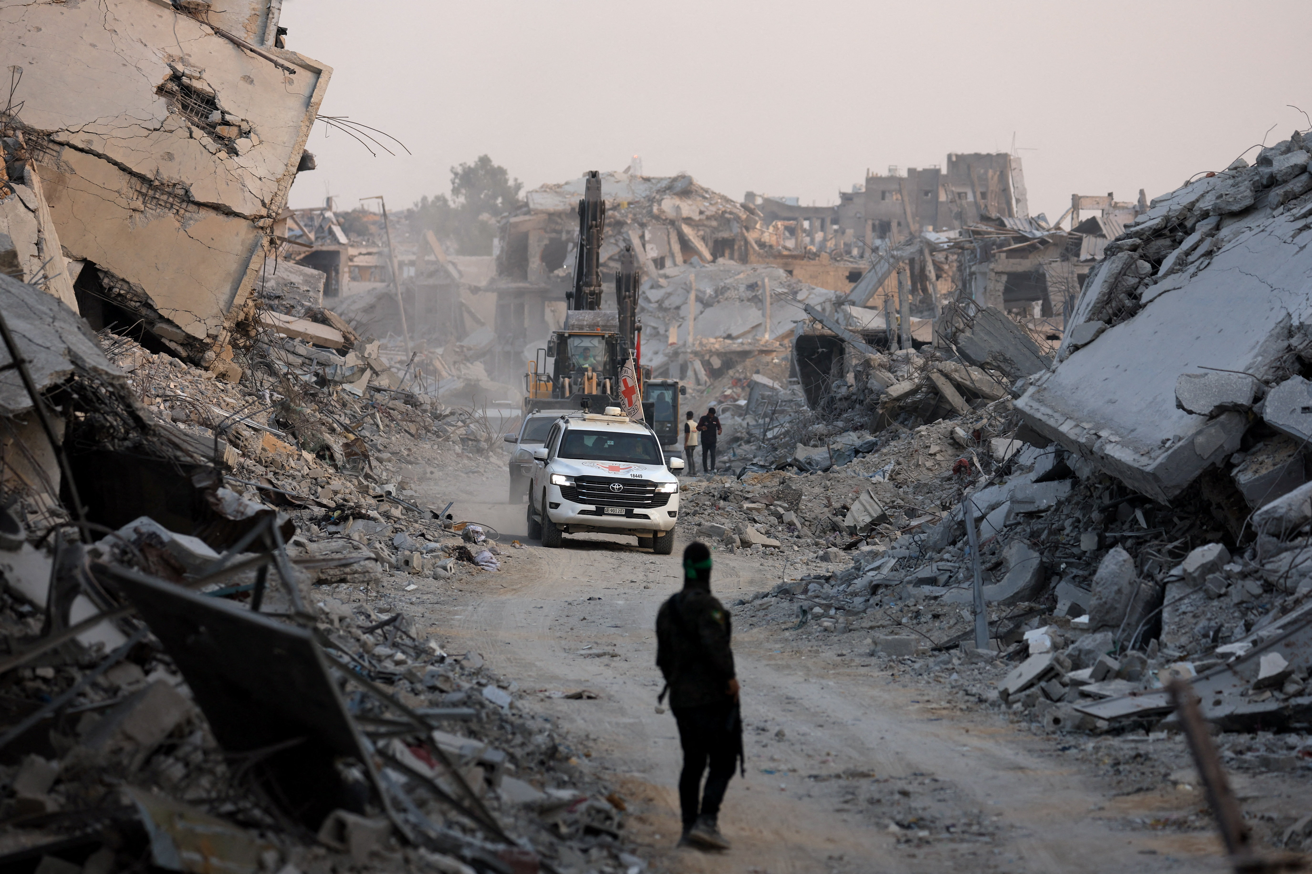Red Cross vehicles drive, after Hamas said that it found the body of an Israeli hostage soldier, in Gaza City
