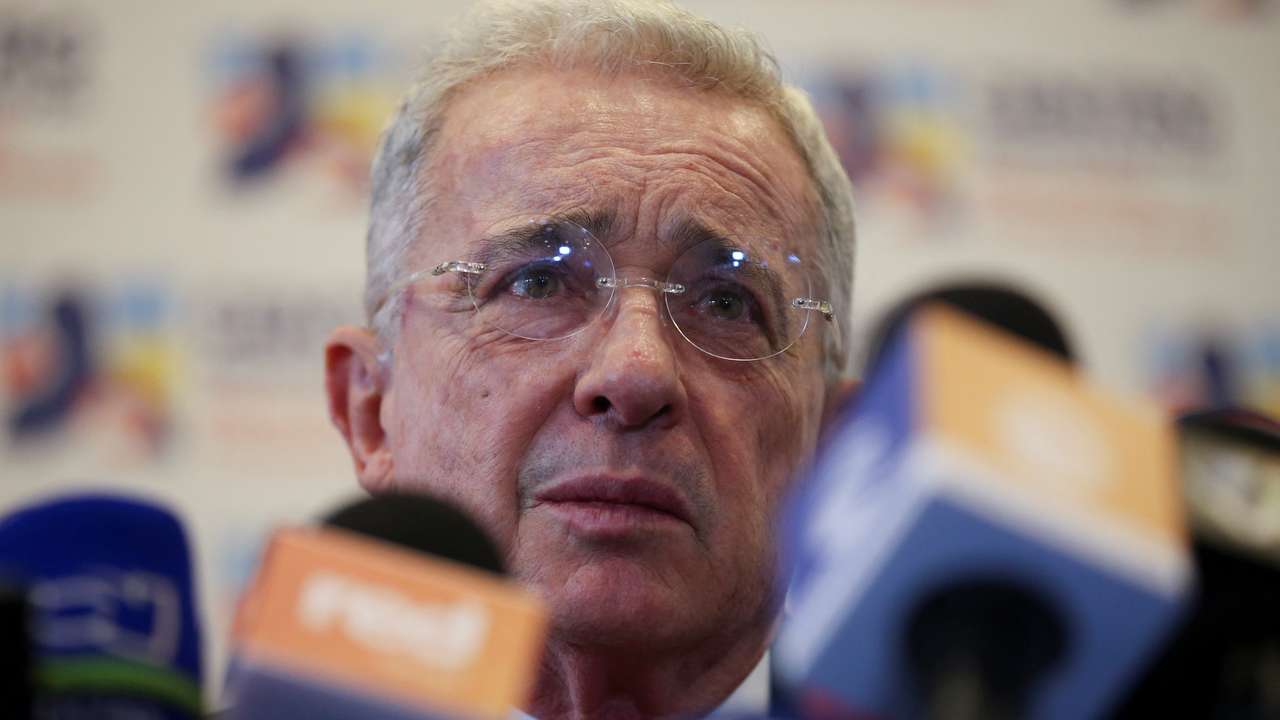 Colombia's former president Alvaro Uribe reacts to the media after his meeting with President-elect Gustavo Petro in Bogota