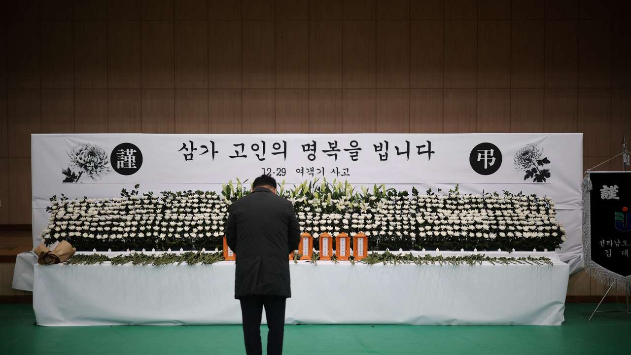 A man mourns at a memorial altar for government officials of Jeollanam-do Office of Education and students who died in the Jeju Air crash at Muan International Airport, in Muan