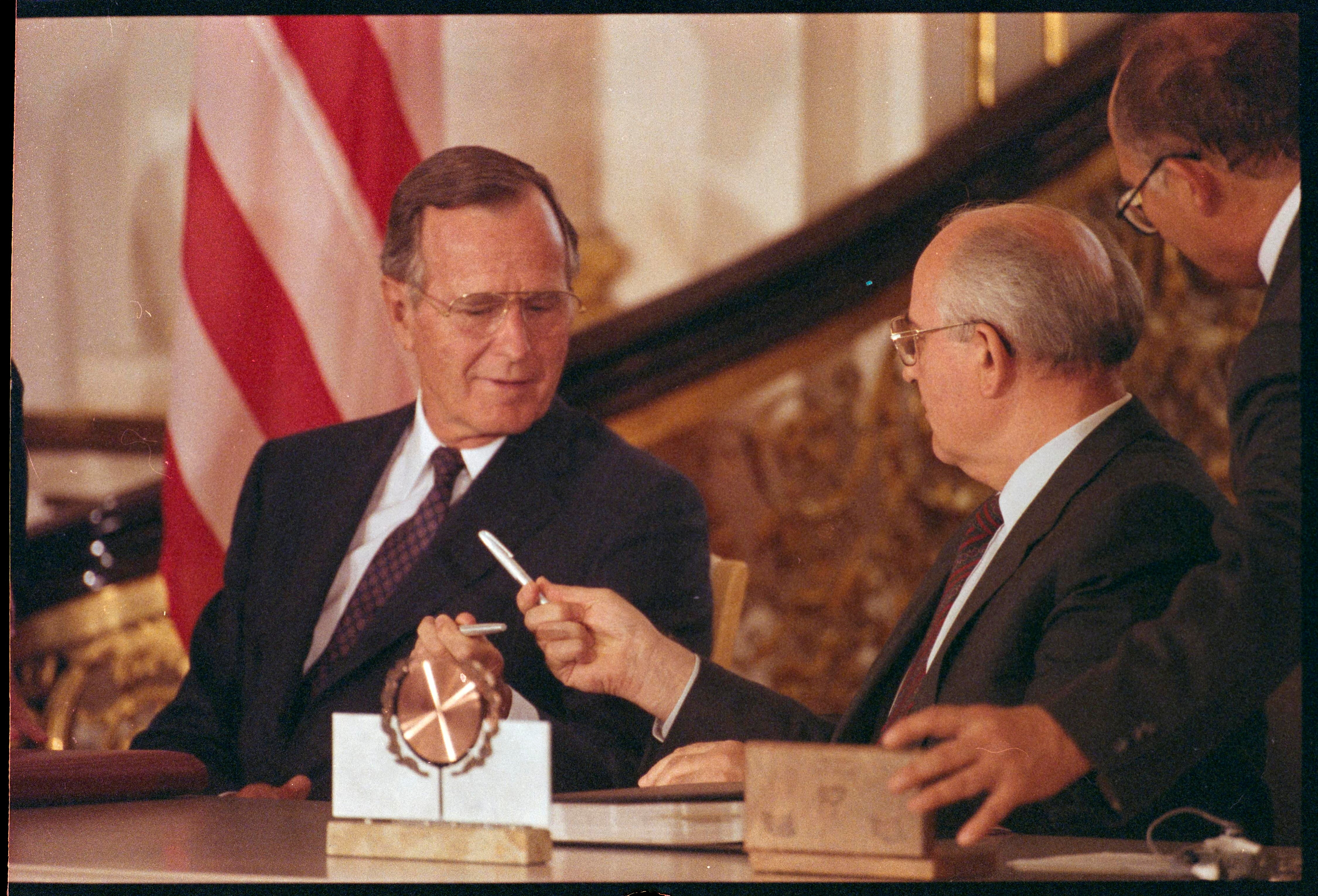 FILE PHOTO: US President George Bush and Soviet President Mikhail Gorbachev exchange pens after signing the START treaty.
