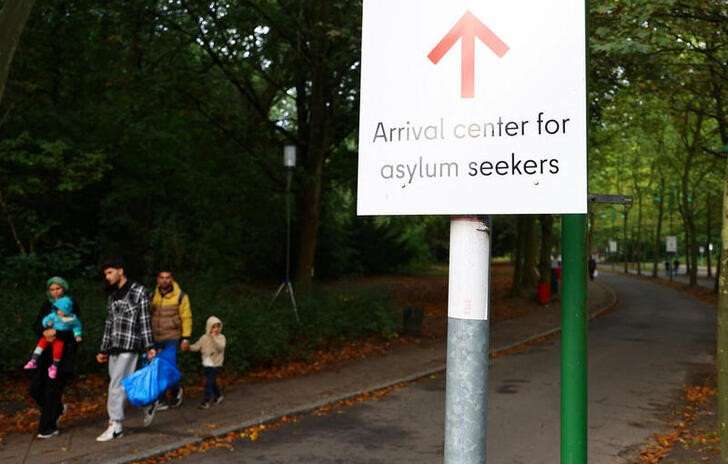 FILE PHOTO: Migrants are pictured at the arrival center for asylum seekers at Berlin's Reinickendorf district