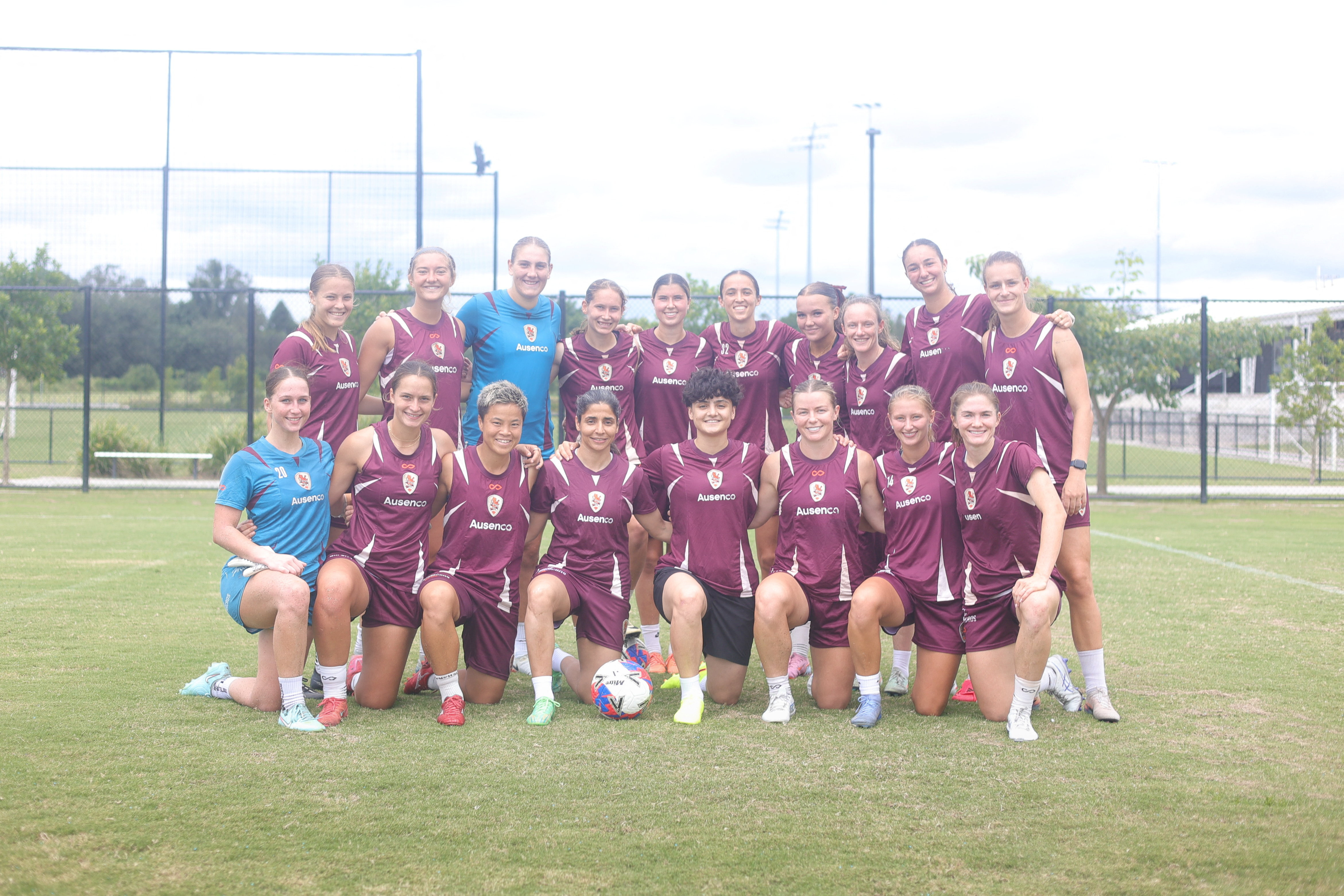 Iranian soccer players Atefeh Ramezanizadeh and Fatemeh Pasandideh pose for a photo with members of Brisbane Roar women's football club, in Brisbane