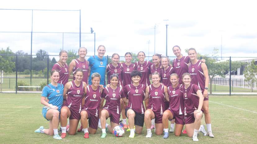 Iranian soccer players Atefeh Ramezanizadeh and Fatemeh Pasandideh pose for a photo with members of Brisbane Roar women's football club, in Brisbane