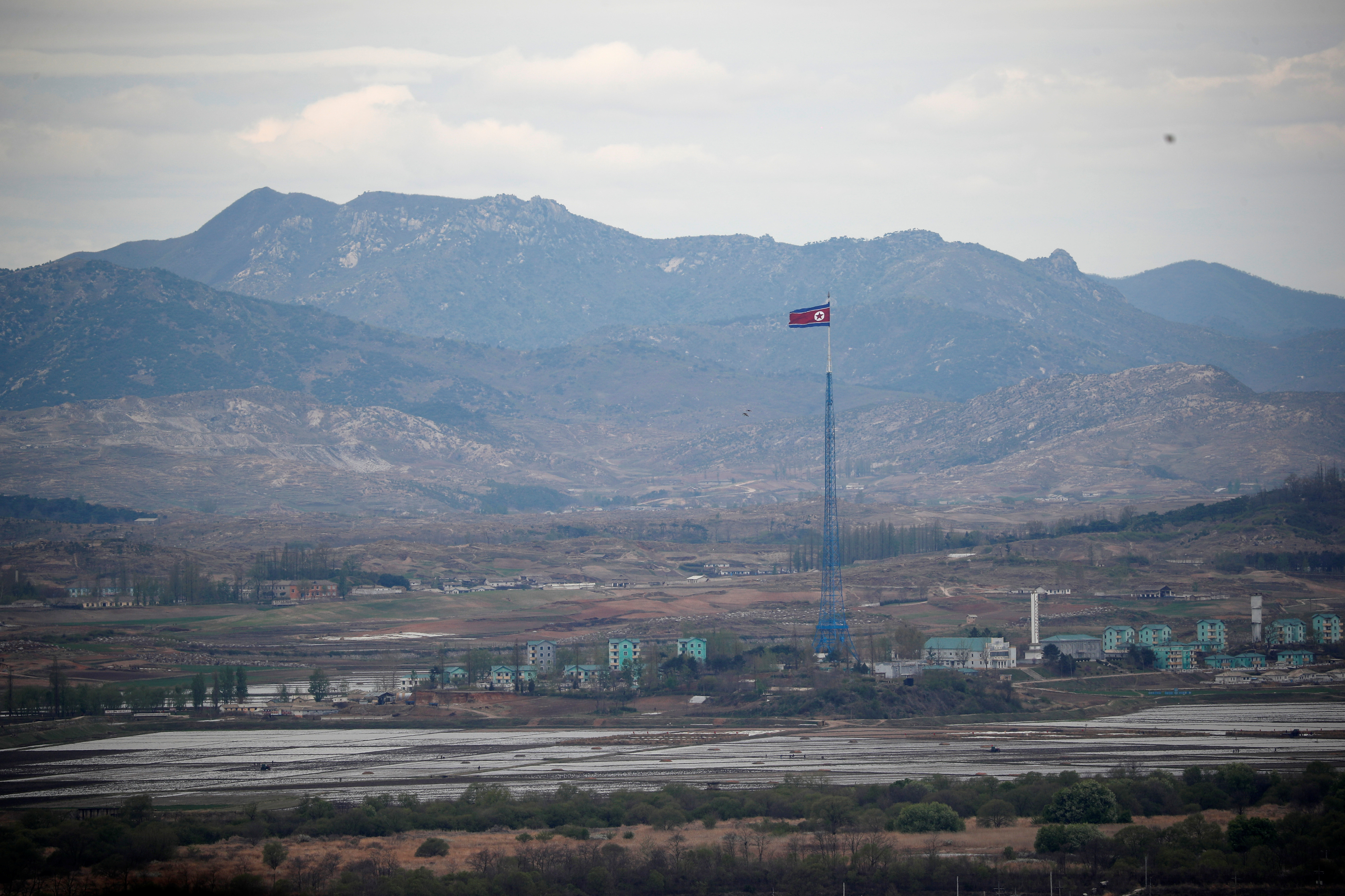 A North Korean flag flutters on top of a 160-metre tower in North Korea's propaganda village of Gijungdong, in this picture taken from the Dora observatory near the demilitarised zone separating the two Koreas, in Paju