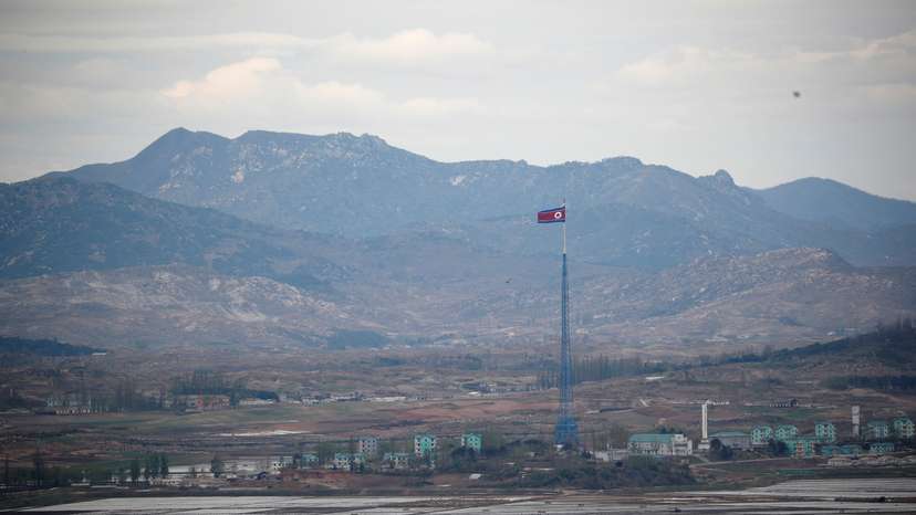 A North Korean flag flutters on top of a 160-metre tower in North Korea's propaganda village of Gijungdong, in this picture taken from the Dora observatory near the demilitarised zone separating the two Koreas, in Paju