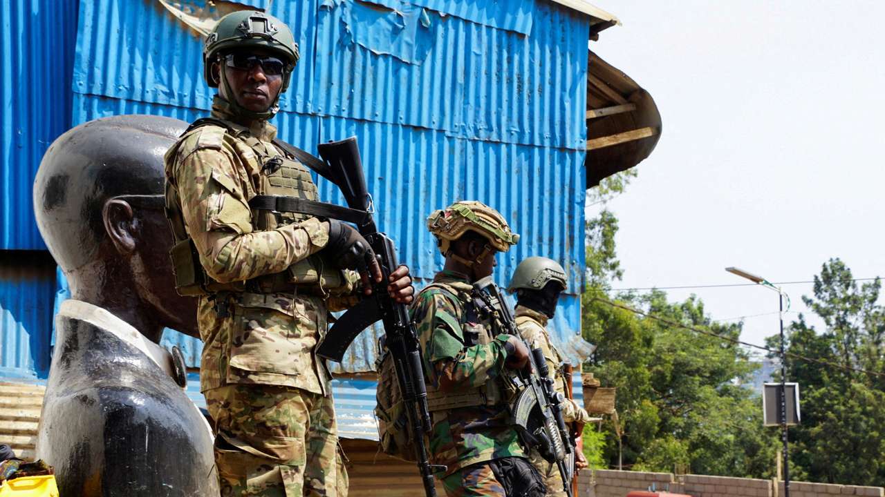 FILE PHOTO: Members of the M23 rebel group stand guard as people attend a rally addressed by Corneille Nangaa, Congolese rebel leader and coordinator of the AFC-M23 movement, in Bukavu, eastern Democratic Republic of Congo February 27, 2025. REUTERS/Victoire Mukenge/File Photo