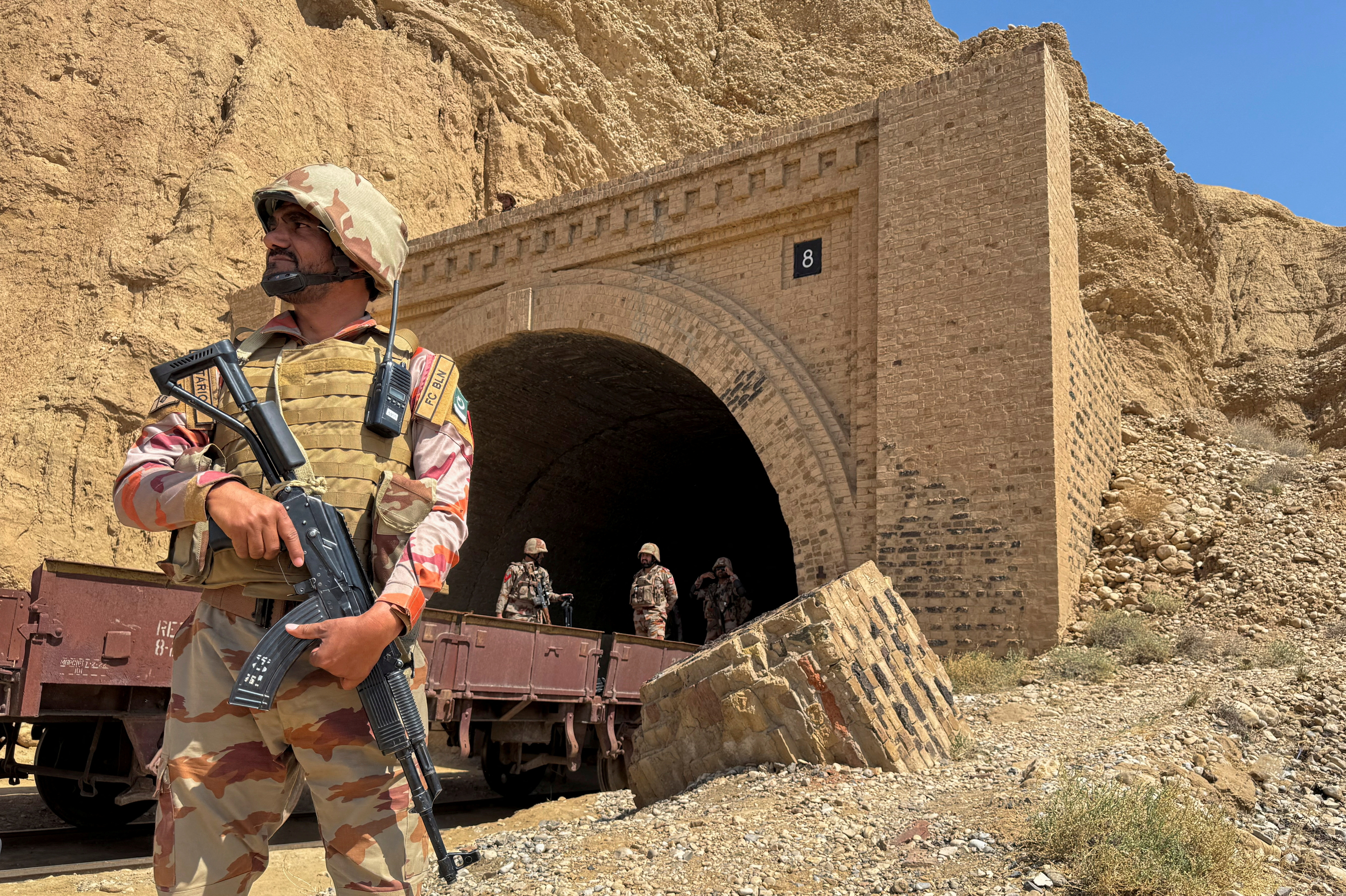 FILE PHOTO: Pakistan army soldiers stand at a tunnel where a train was attacked by separatist militants, in Bolan