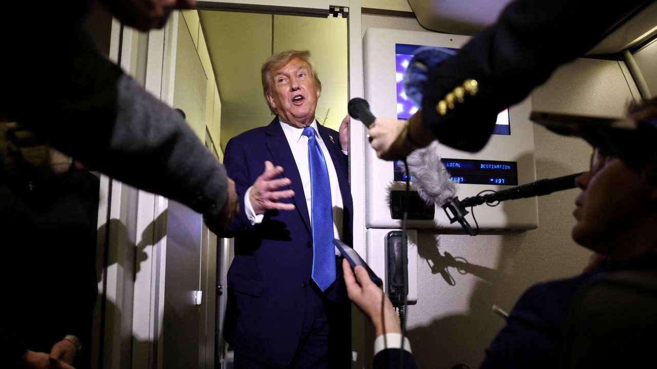 U.S. President Trump speaks to reporters aboard Air Force One on his way back to Washington