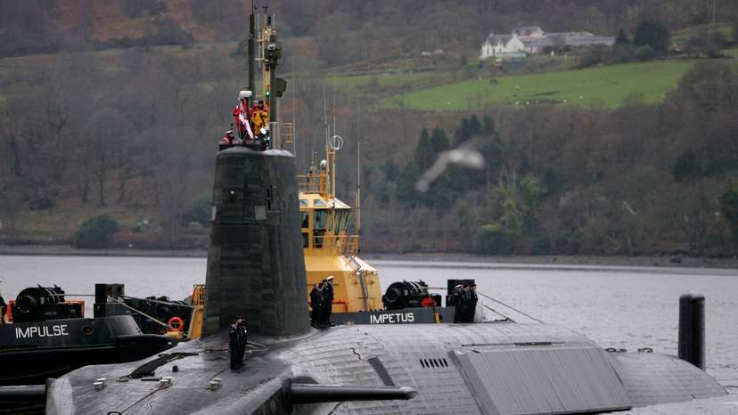 FILE PHOTO: Crew from HMS Vengeance stand on their vessel as they return along the Clyde river to the Faslane naval base near Glasgow