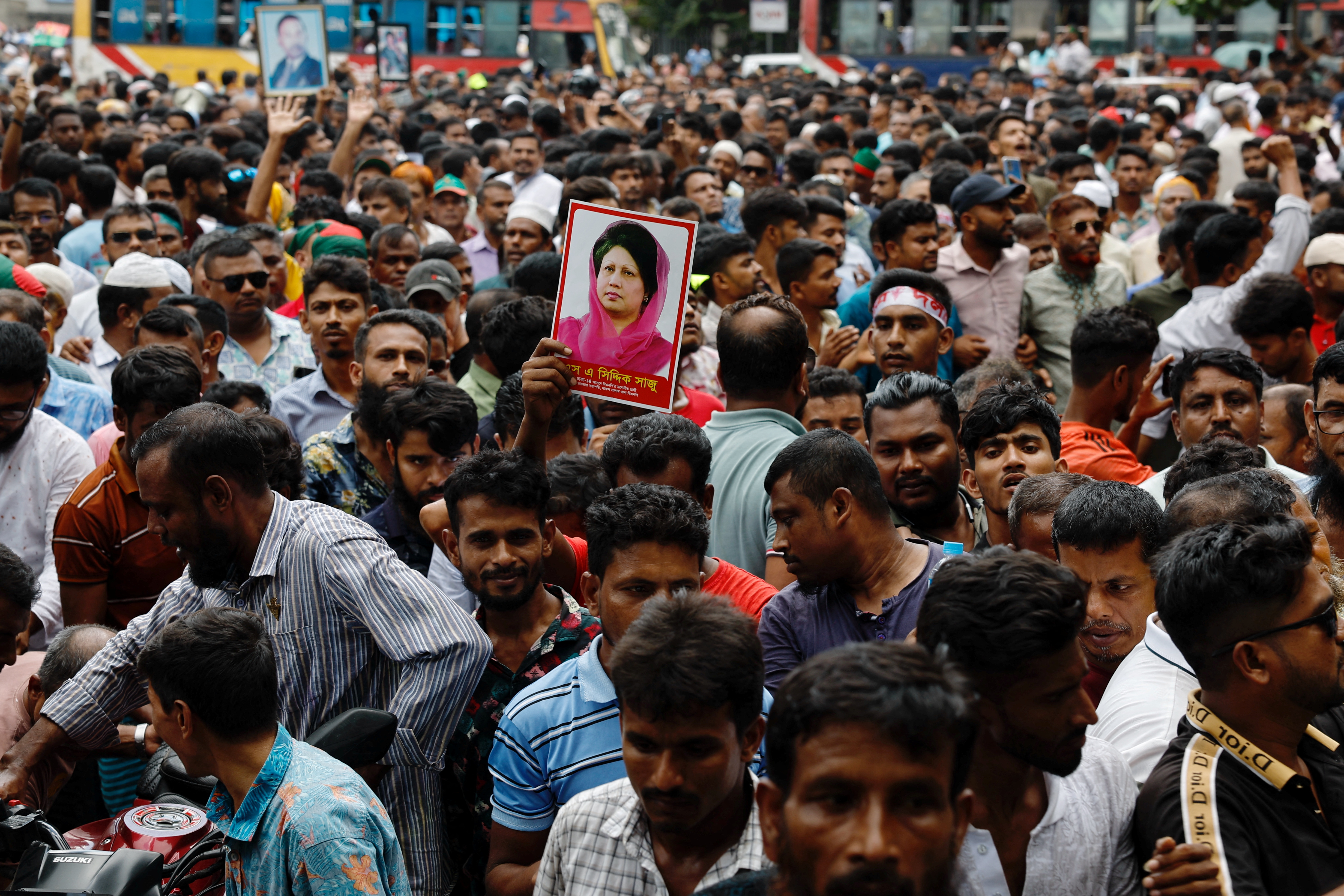 Supporter of Bangladesh Nationalist Party (BNP) holds a picture of former Prime Minister Khaleda Zia while joining in a rally, days after the resignation of former Prime Minister Sheikh Hasina