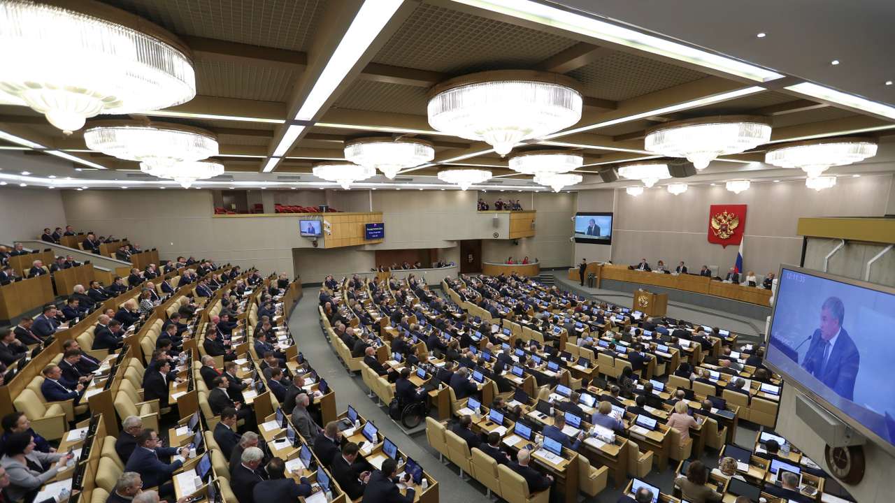 Members of Russia's lower house of parliament attend a session to consider constitutional changes in Moscow