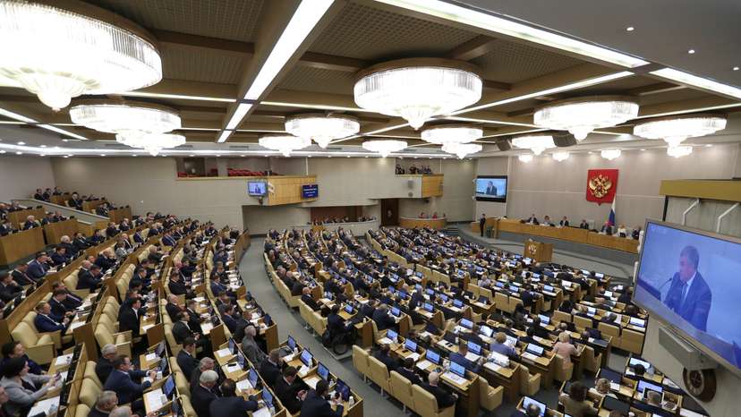 Members of Russia's lower house of parliament attend a session to consider constitutional changes in Moscow