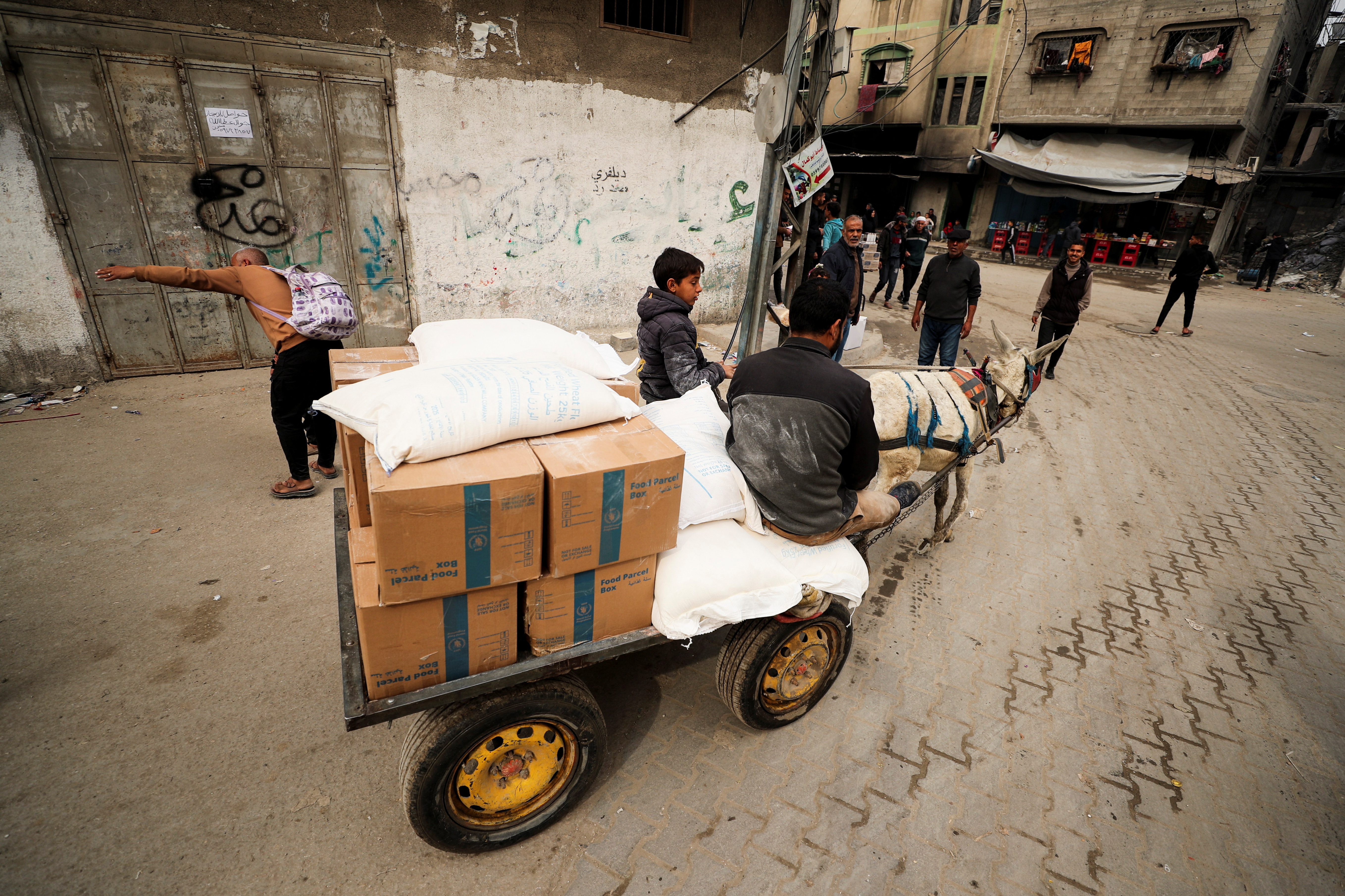Palestinians wait to receive aid, in Gaza City