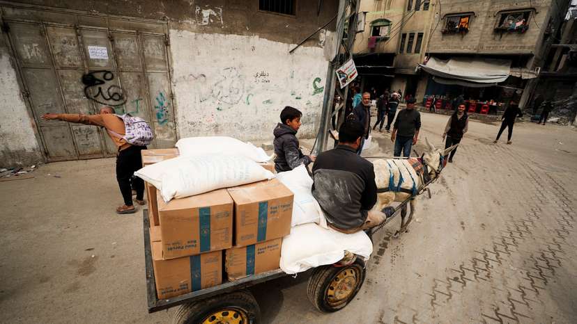 Palestinians wait to receive aid, in Gaza City