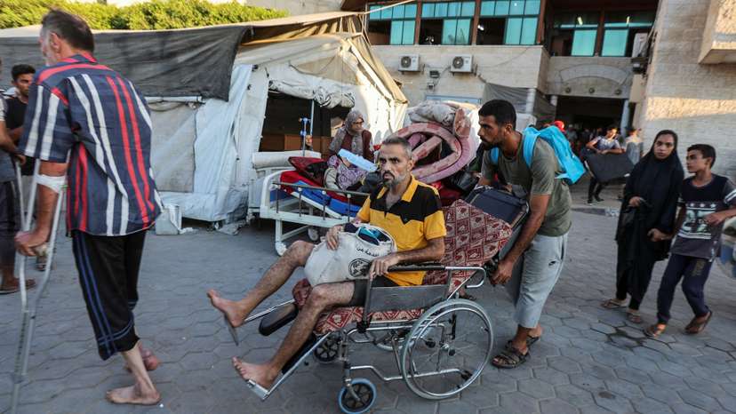 Palestinian patients flee Al-Aqsa Martyrs hospital, in Deir Al-Balah