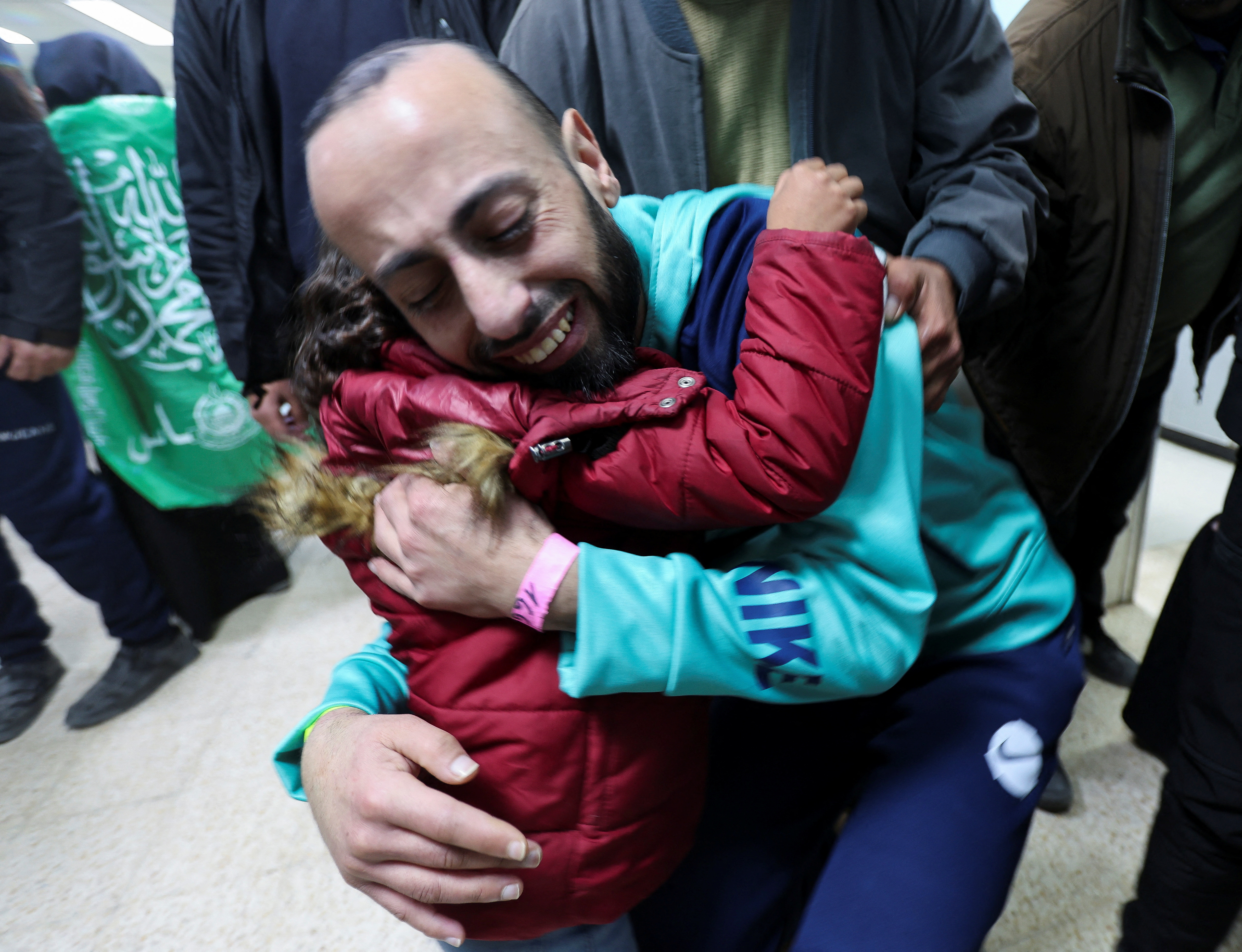 Tarek Rabie Safi, a freed Palestinian prisoner, hugs his daughter after being released by Israel as part of a hostages-prisoners swap and a ceasefire deal in Gaza between Hamas and Israel, in Khan Younis, in the southern Gaza Strip