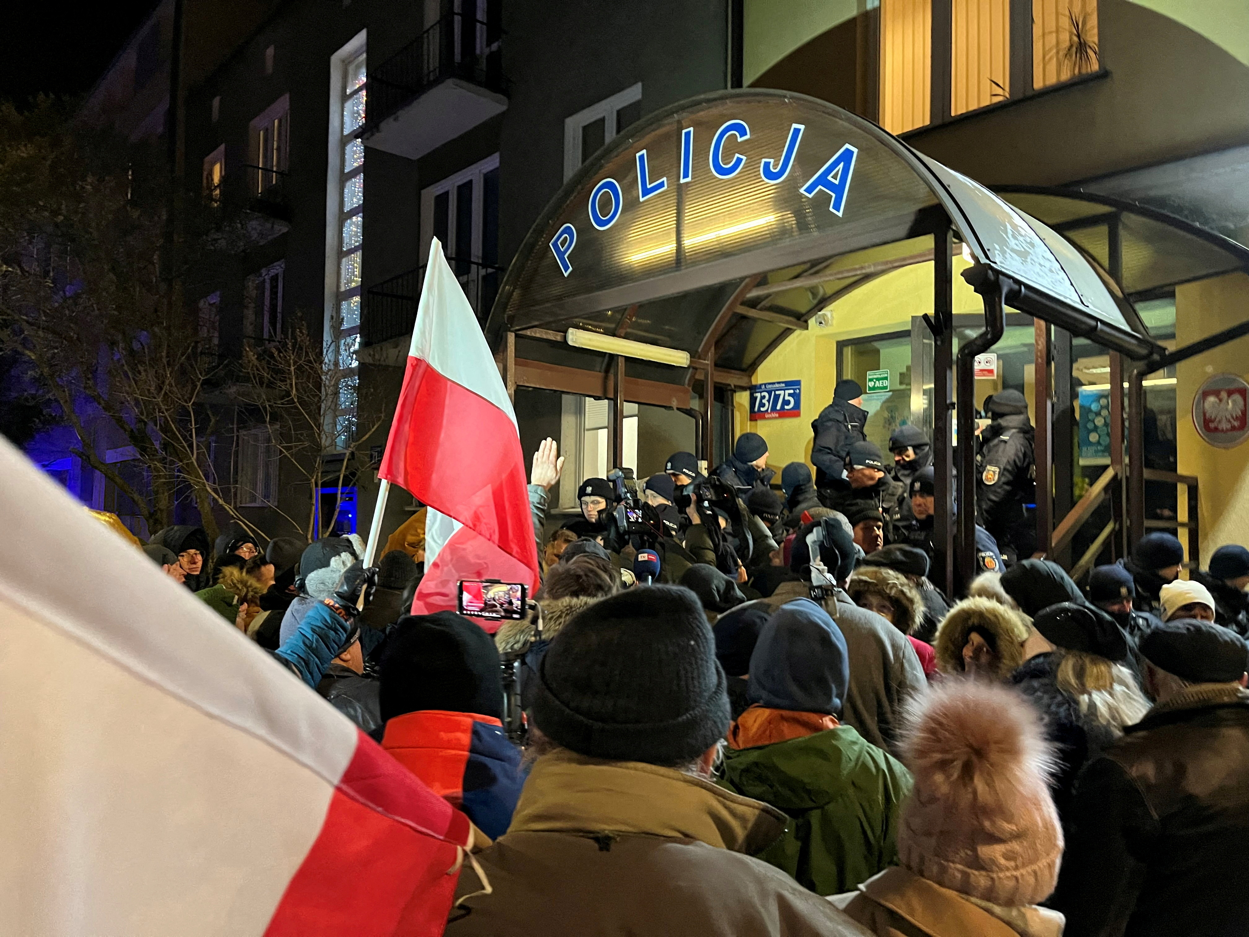 Protesters gather in support of former Interior Minister Kaminski and his deputy Wasik from PiS party, in front of the police station where both politicians are detained in Warsaw
