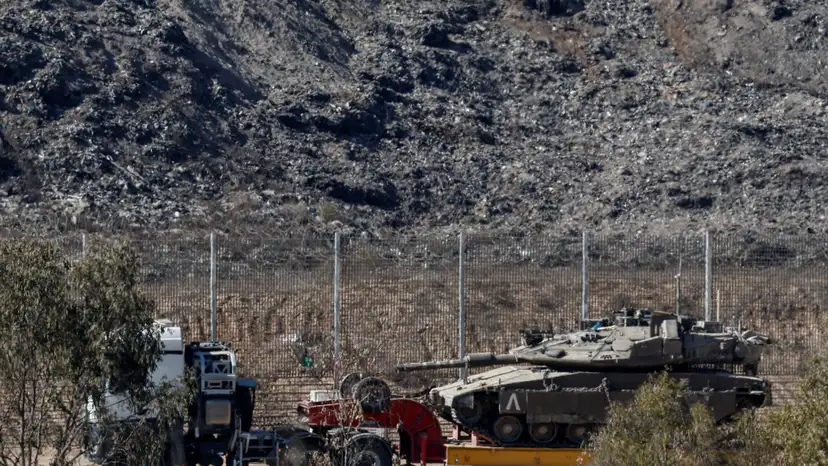 A truck transports a tank on the Israeli side of the border with Gaza, in Israel