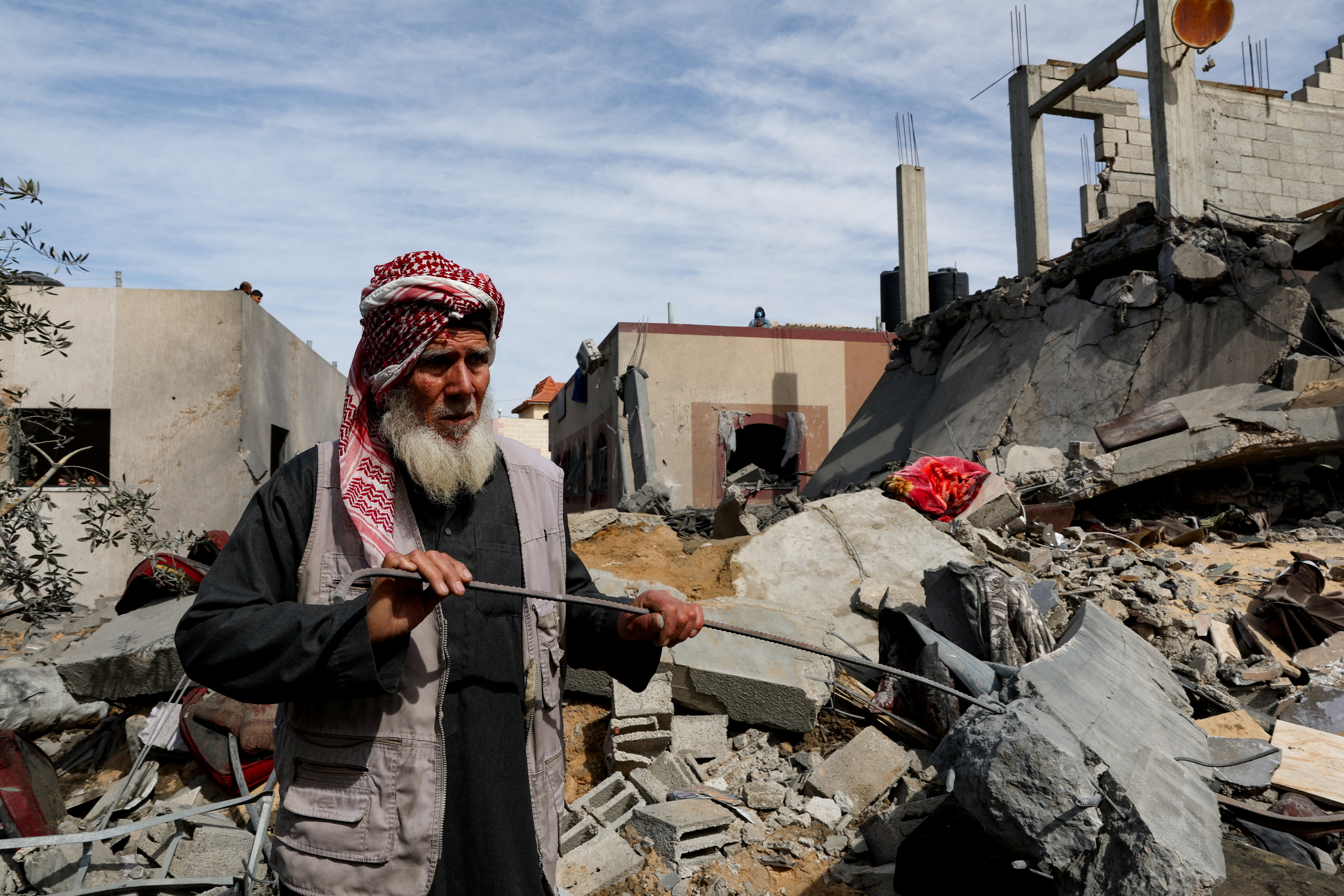 Palestinians gather at the site of an Israeli strike on a house, in Rafah