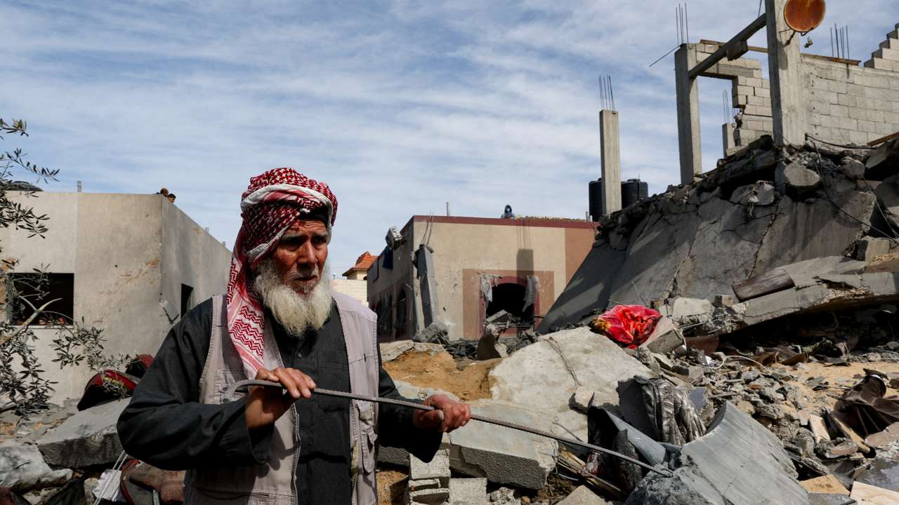 Palestinians gather at the site of an Israeli strike on a house, in Rafah