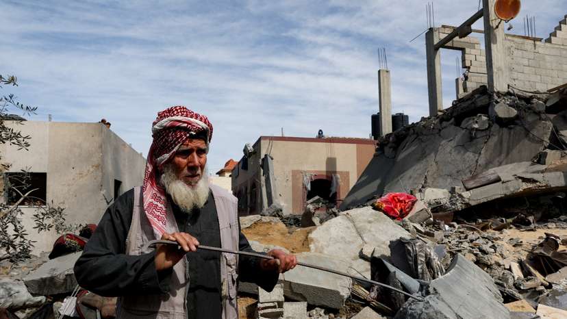 Palestinians gather at the site of an Israeli strike on a house, in Rafah
