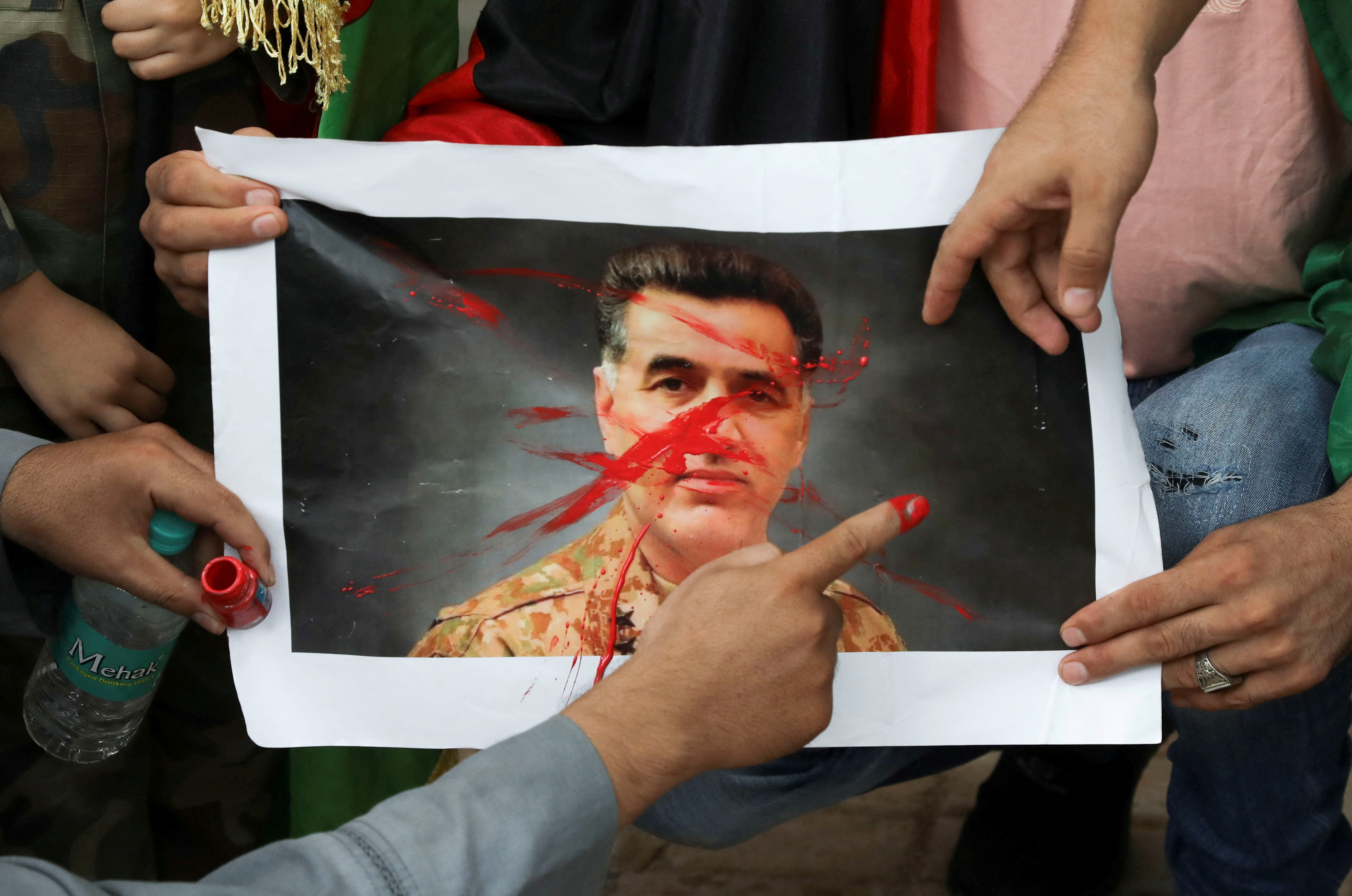Afghan nationals hold a protest against Pakistan near a police station in New Delhi