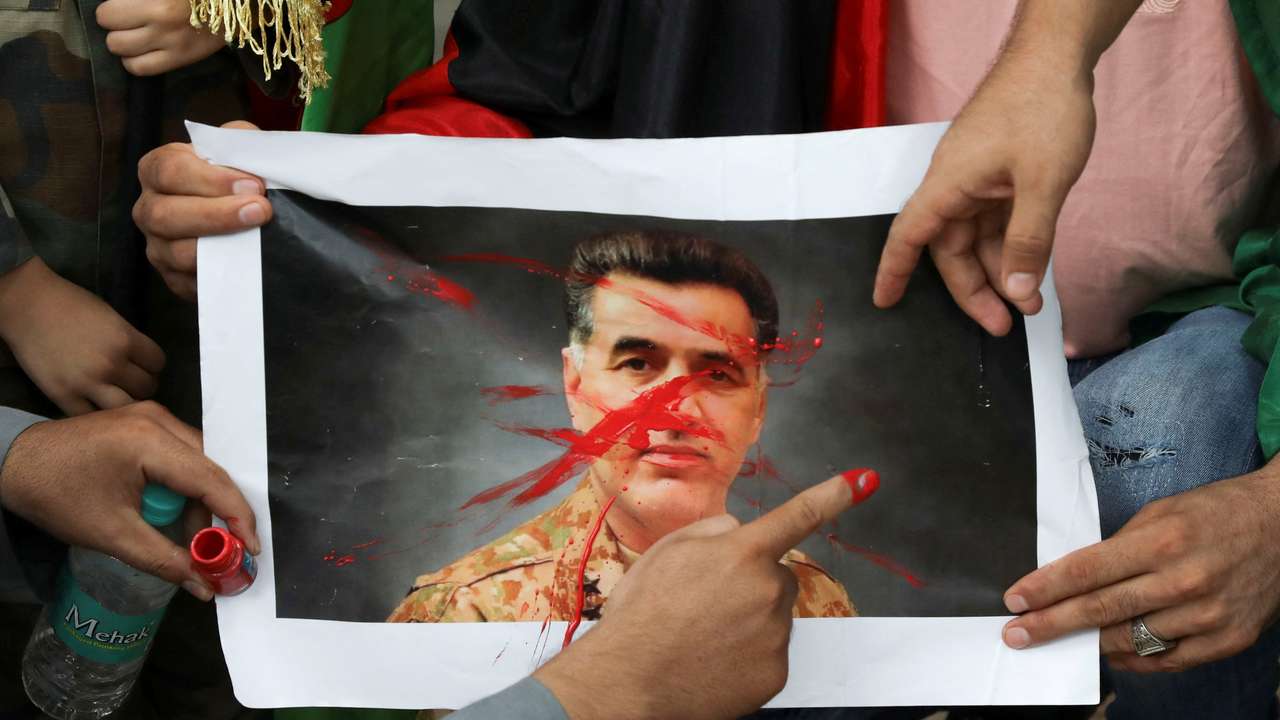 Afghan nationals hold a protest against Pakistan near a police station in New Delhi