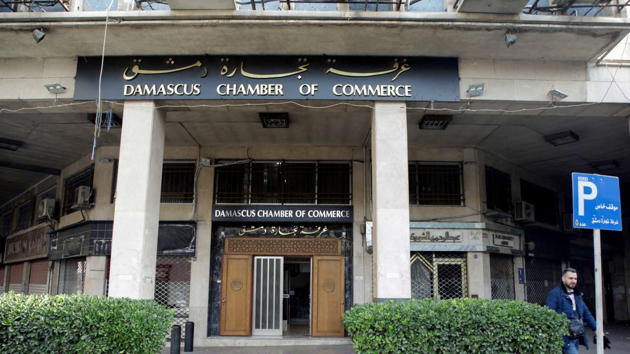 A man walks near the Damascus Chamber of Commerce in Damascus