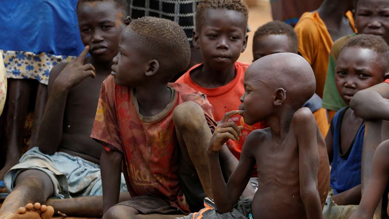 Children wait to eat boiled leaves at IDP Camp in South Kordofan, Sudan