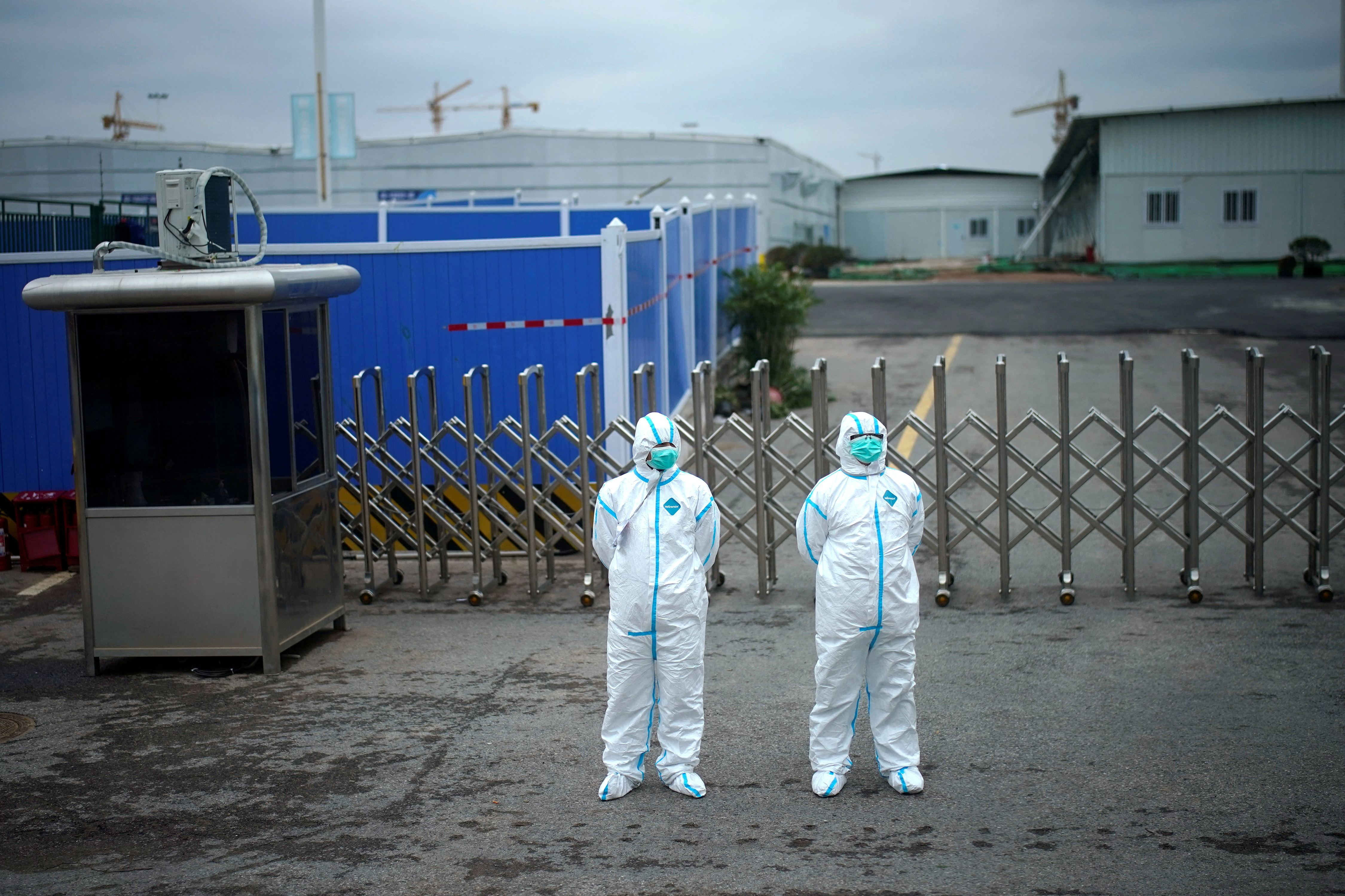 FILE PHOTO: Workers in protective suits are seen at the Leishenshan Hospital, a makeshift hospital for treating patients with the coronavirus disease (COVID-19), in Wuhan